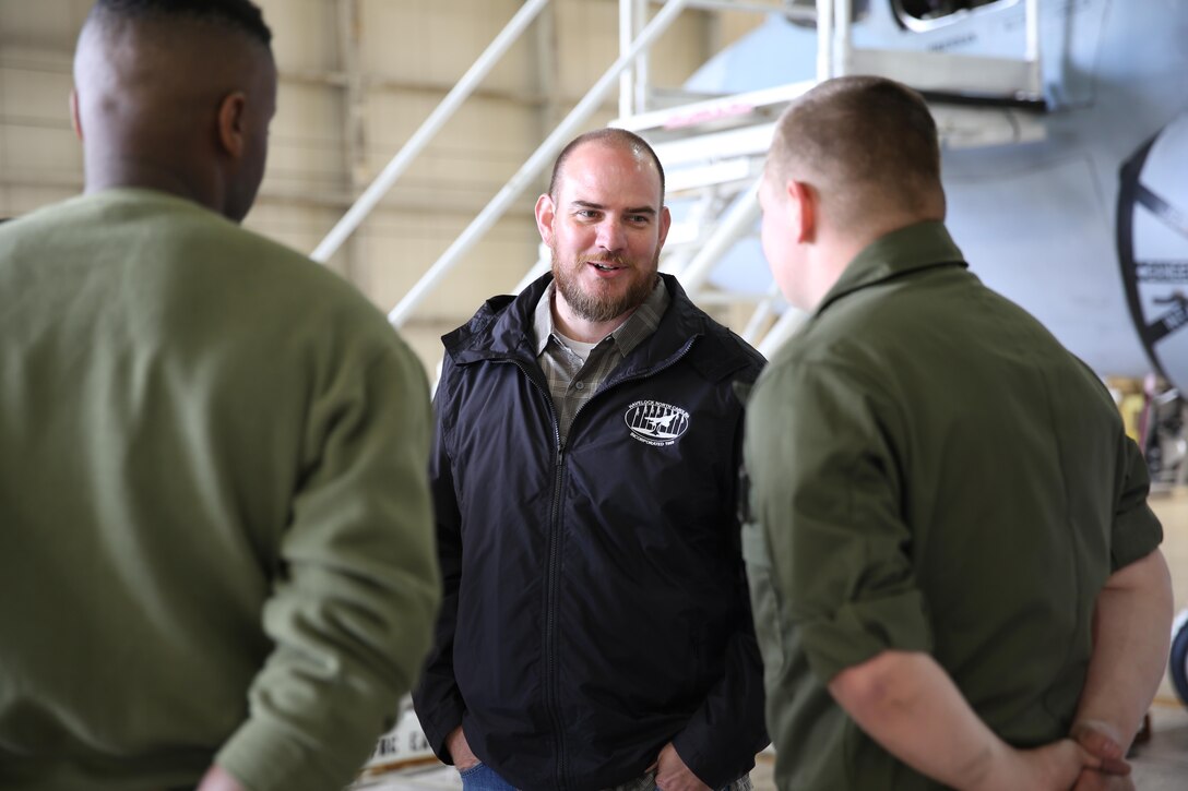 Havelock Mayor William Lewis, center, speaks with Marines from Marine Tactical Electronic Warfare Training Squadron 1 in an aircraft hangar about their jobs at Marine Corps Air Station Cherry Point, N.C., April 6, 2016. According to Lewis, the tour was part of his efforts to strengthen the already well-established relationship between the Havelock and Cherry Point communities. He looks to grow community ties with the air station by understanding the mission of the 2nd Marine Aircraft Wing and its squadrons, said Lewis. (U.S. Marine Corps photo by Lance Cpl. Mackenzie Gibson/Released.)