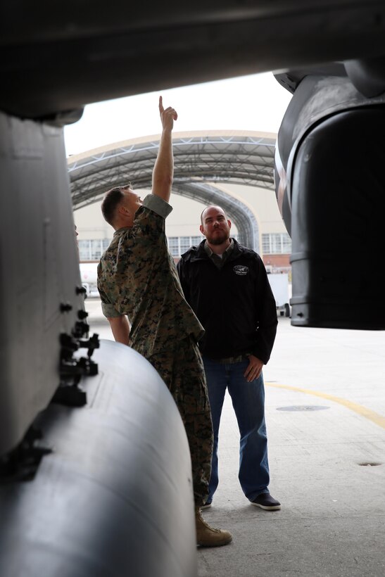 Col. Eric Austin, left, describes the functions of an AV-8B Harrier to Havelock Mayor William Lewis during a tour of the flight line at Marine Corps Air Station Cherry Point, N.C., April 6, 2016. According to Lewis, the tour was part of his efforts to strengthen the already well-established relationship between the Havelock and Cherry Point communities. He looks to grow community ties with the air station by understanding the mission of the 2nd Marine Aircraft Wing and its squadrons, said Lewis. Austin is the commanding officer of Marine Aircraft Group 14. (U.S. Marine Corps photo by Lance Cpl. Mackenzie Gibson/Released.)
