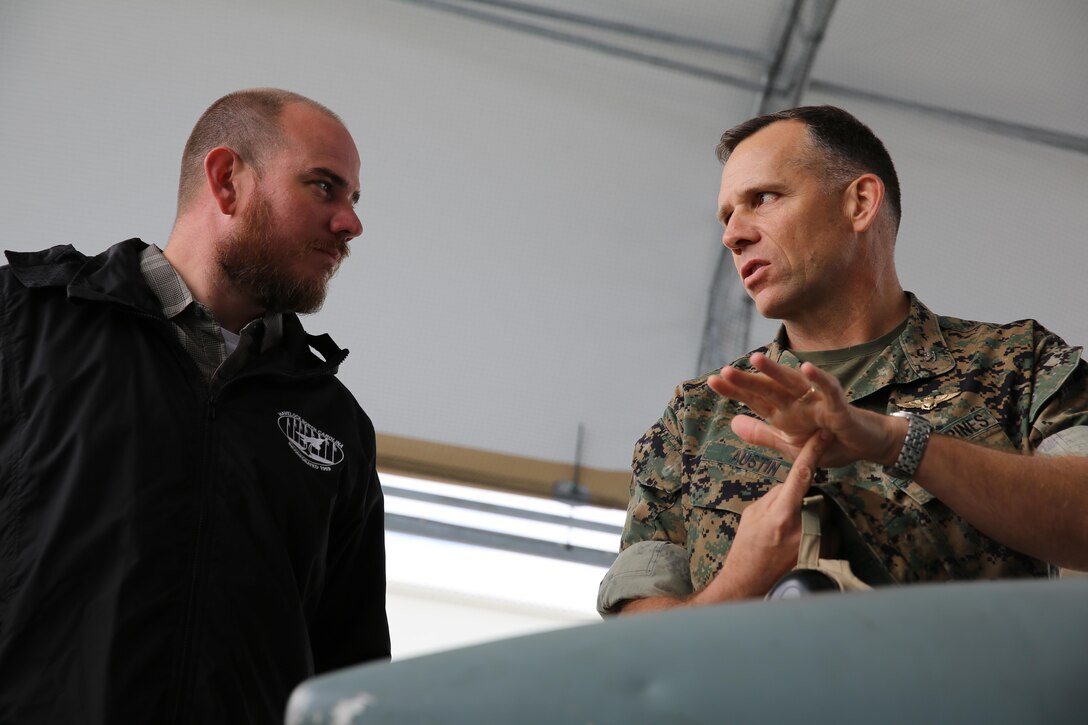 Col. Eric Austin, right, explains the capabilities of the AV-8B Harrier to Havelock Mayor William Lewis during a tour of the flight line at Marine Corps Air Station Cherry Point, N.C., April 6, 2016. According to Lewis, the tour was part of his efforts to strengthen the already well-established relationship between the Havelock and Cherry Point communities. He looks to grow community ties with the air station by understanding the mission of the 2nd Marine Aircraft Wing and its squadrons, said Lewis. Austin is the commanding officer of Marine Aircraft Group 14. (U.S. Marine Corps photo by Lance Cpl. Mackenzie Gibson/Released.)