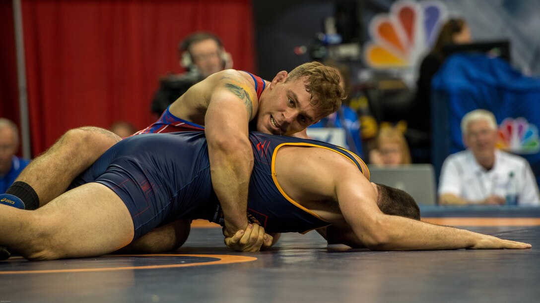 1st Lt. Daniel Miller, a member of the All-Marine Wrestling team, gets behind his opponents back to score two points during a match at the 2016 U.S. Olympic Wrestling Trials in Iowa City, Iowa April 9. Miller competed in the 215–pound weight class and was one of four Marines competing at the event.