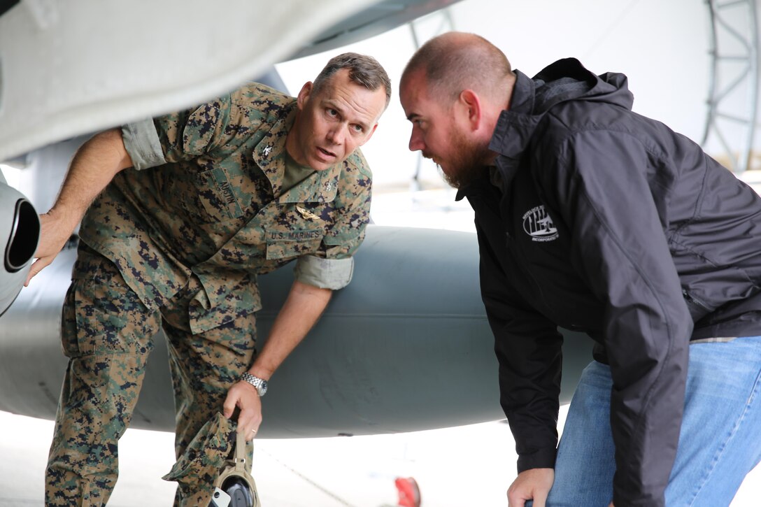 Col. Eric Austin, left, discusses the functions of an AV-8B Harrier with Havelock Mayor William Lewis during a tour of the flight line at Marine Corps Air Station Cherry Point, N.C., April 6, 2016. According to Lewis, the tour was part of his efforts to strengthen the already well-established relationship between the Havelock and Cherry Point communities. He looks to grow community ties with the air station by understanding the mission of the 2nd Marine Aircraft Wing and its squadrons, said Lewis. Austin is the commanding officer of Marine Aircraft Group 14. (U.S. Marine Corps photo by Lance Cpl. Mackenzie Gibson/Released.)