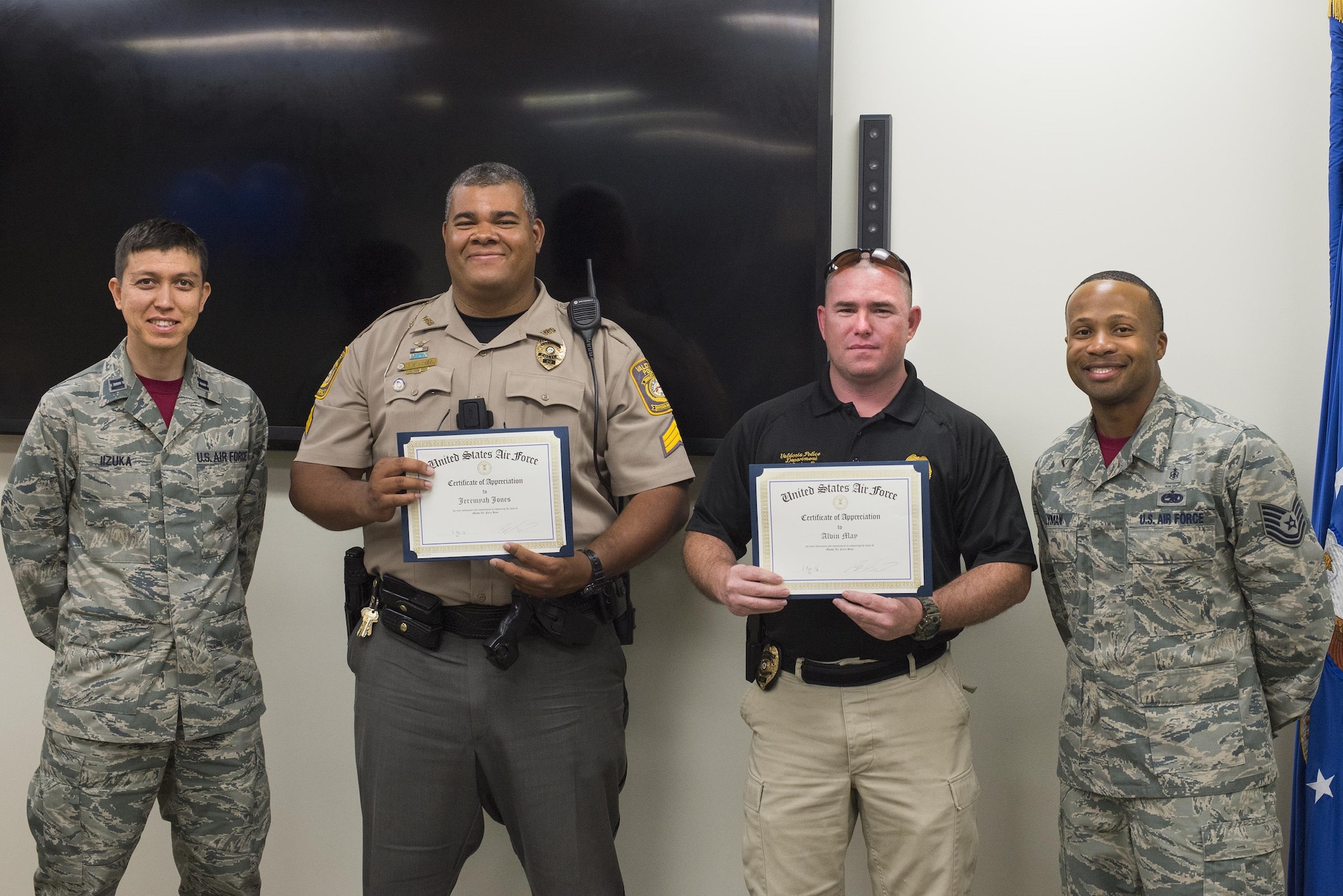 U.S. Air Force Capt. Koji Iizuka, left, and Tech. Sgt. Ronnie Lyman, right, 23d Medical Operations Squadron, present Valdosta Police Department Sgt. Jeremyah Jones, center left, and patrolman Alvin May, with a certificate of appreciation at a lunch and learn, April 8, 2016, at Moody Air Force Base, Ga. The officers received the certificates after speaking to Airmen about the dangers irresponsible drinking in observation of Alcohol Awareness Month. (U.S. Air Force photo by Airman Daniel Snider/Released)
