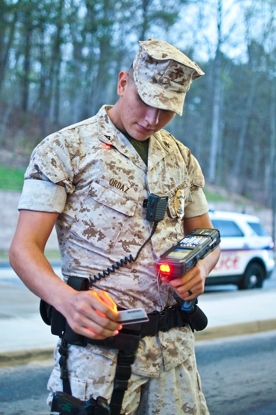 Lance Cpl. Christian Ordaz, Security Battalion military police officer, scans an I.D. card with the RAPIDGate identification scanner aboard Marine Corps Base Quantico. The near-instantaneous card scanner will improve security on the base and streamline access for commercial vehicles traveling onto the installation.