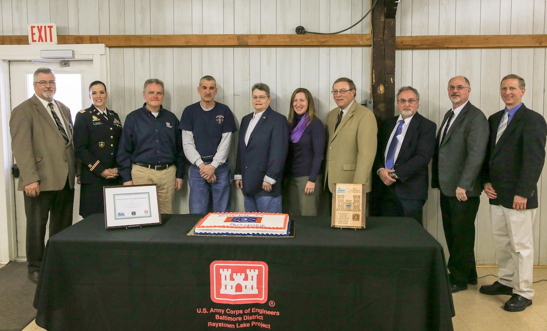 Taking part in the 2015 Excellence in Partnership Award Ceremony, from left, Jeff Thomas, Huntingdon County Commissioner; Captain Kelly Giraud, Baltimore District; Eddie Belk, Army Corps Headquarters; Brian Hunsicker, MVFD president; Marilyn Jones and Heather Burke, Corps Foundation; Keith Black, from Rep. Rich Irvin's office; Scott Walls and Mark Sather, Huntingdon County Commissioners, and Park Ranger Allen Gwinn, Raystown Lake.  
