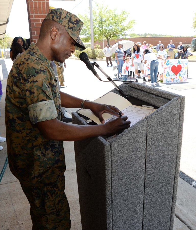Col. James Carroll III, commanding officer, Marine Corps Logistics Base Albany, signs a proclamation to kick-off the installation’s celebration of the “Month of the Military Child,” here, April 8. The signing and a parade commenced at the installation’s Child Development Center and ended with a reception at Covella Pond. The annual event is a month set aside to recognize the many sacrifices made by the military’s littlest warfighters, the children.