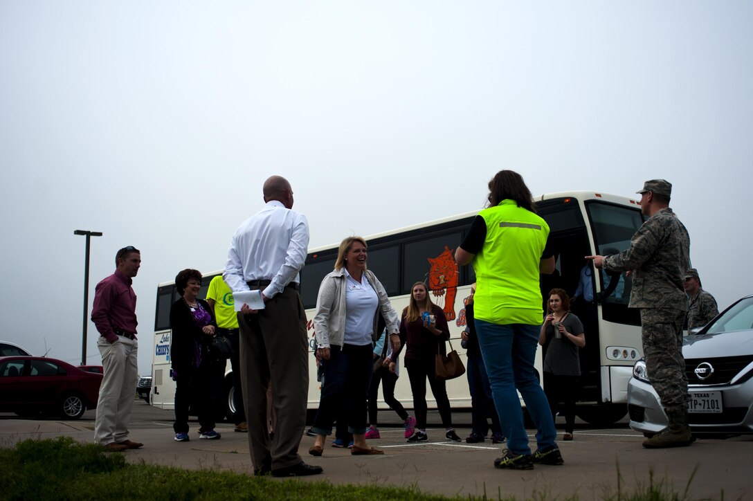 Leadership San Angelo members exits a bus to meet with Joseph J. Gomos, 312th Training Squadron fire protection flight chief, and U.S. Air Force Col. Kurt A. Wendt, 17th Training Group Deputy Commander, for a tour of the Louis F. Garland Department of Defense Fire Academy on Goodfellow Air Force Base, Texas, April 14, 2016. Leadership San Angelo spends an entire day each month touring specific facilities to broaden their leadership skills and learn more about the local community. (U.S. Air Force photo by Senior Airman Scott Jackson/Released)