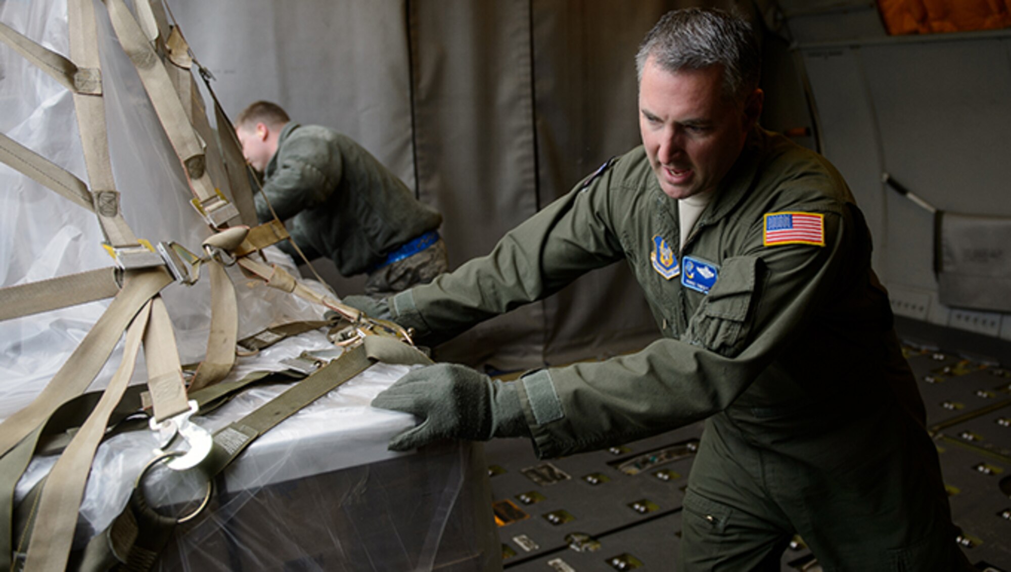 Senior Master Sgt. Tiger Platt, 76th Airlift Squadron boom operator, moves a cargo pallet March 25, 2016, at Ramstein Air Base, Germany. Platt and a crew of 76th AS reservists flew humanitarian cargo to Ramstein where it will be loaded and sent on to its final destination in Afghanistan. (U.S. Air Force photo/Staff Sgt. Armando A. Schwier-Morales)