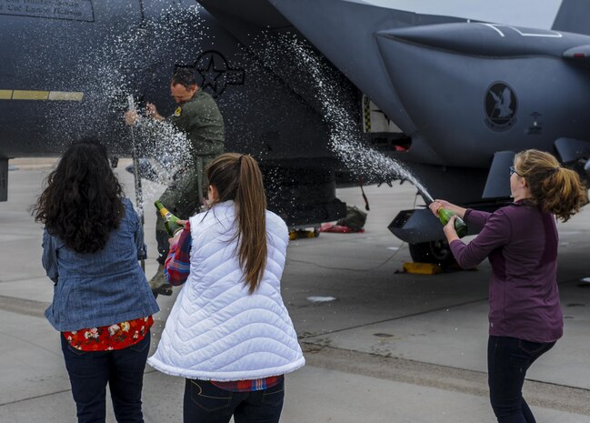 Brig. Gen. Christopher Short, 57th Wing commander, is showered by champagne after disembarking his F-15 Strike Eagle during his fini flight at Nellis Air Force Base, Nev., April 8, 2016.  It’s traditional for the pilot to be sprayed down by champagne or water hose once they exit their aircraft after a fini flight. (U.S. Air Force photo by Airman 1st Class Kevin Tanenbaum)