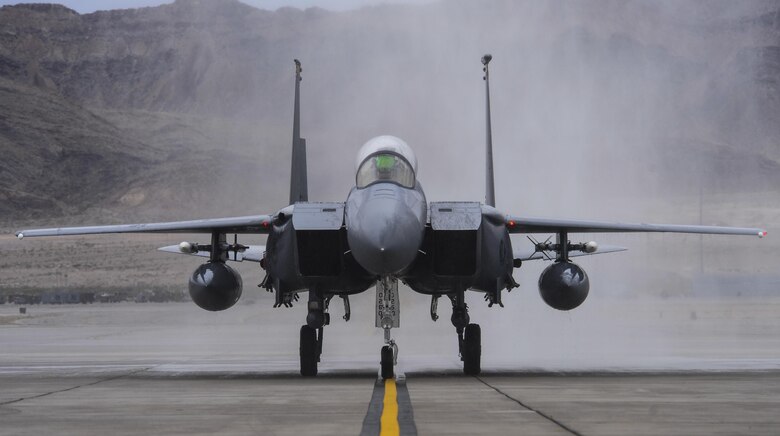 Brig. Gen. Christopher Short, 57th Wing commander, taxis down the runway in an F-16 Fighting Falcon after being sprayed by fire trucks during his fini flight at Nellis Air Force Base, Nev., April 8, 2016. A fini flight is a pilot’s last flight in an aircraft before he/she leaves a squadron, a wing, or retires from the Air Force. (U.S. Air Force photo by Airman 1st Class Kevin Tanenbaum)