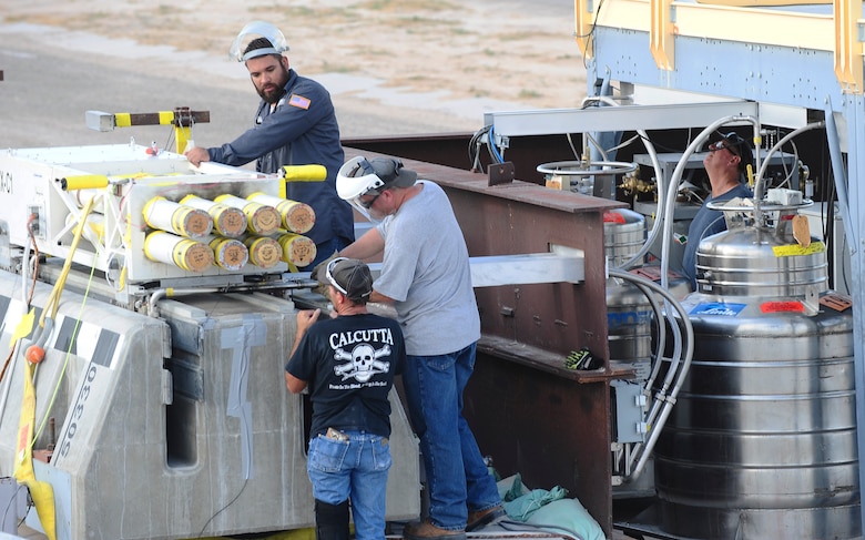 Technicians from the 846th Test Squadron at Holloman Air Force Base, N.M., prepare a rocket-propelled sled for a launch here Aug. 18, 2015. Teams of engineers, technicians and computer program experts all worked together to break the world record for speed on a magnetically-levitated sled system. The test, taking place March 4, 2016, sent the sled accelerating at 633 mph – shattering the previous record of 513 mph. (U.S. Air Force photo by Airman 1st Class Randahl J. Jenson)   