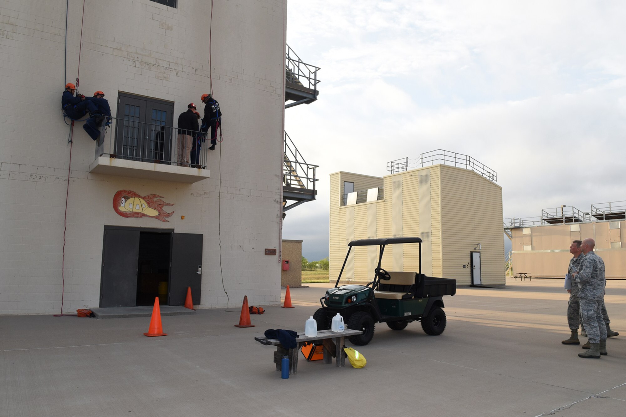 U.S. Air Force Lt. Col. Matthew D. Welling, 312th Training Squadron Commander, and Brig. Gen. Andrew A. Croft, Air Education and Training Command Plans, Programs, Requirements and Assessments Director, watch a rappelling class at the Louis F. Garland Department of Defense Fire Academy on Goodfellow Air Force Base, Texas, April 12, 2016. Croft toured the fire academy and observed different aspects of fire protection training. (U.S. Air Force photo by Staff Sgt. Laura R. McFarlane/Released)