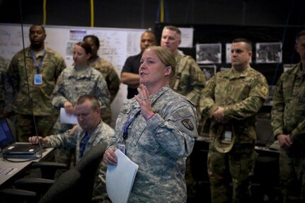 Lt. Col. Renie Bright, commander of the 915th Contracting Battalion, briefs Distinguished Visitors (DVs) about the 915th Contingency Contracting Administration Services (CCAS) mission exercise to multiple General Officers and Senior Executive Service personnel who attended the DV Day Event during Operational Contract Support Joint Exercise.
