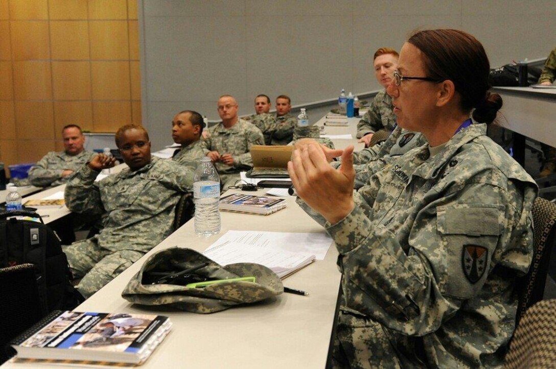 Sgt. Maj. Kathleen Sciortino, sergeant major with the 915th Contingency Contracting Battalion, discusses contingency contracting procedures during academics week.  Looking on during the discussion is Staff Sgt. Sandra Jeanlouis, a contracting specialist also with the 915th.