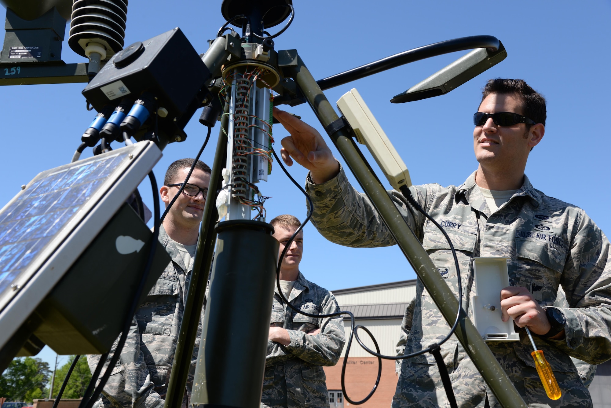 First Lt. Rob Curry, 14th Student Squadron, conducts training on maintenance checks and cleaning for a Tactical Meteorological Equipment-53 Sensor with 14th Operations Support Squadron Weather Flight members April 5 at Columbus Air Force Base, Mississippi. The TMQ-53 Sensor's capabilities include the tracking of wind speeds, airfield pressure, visibility, precipitation and altimeter settings. The weather readings are put into a weather model to help predict weather patterns and are used in deployed environments for daily reports to aircrews preparing for missions. (U.S. Air Force photo/Airman 1st Class John Day)