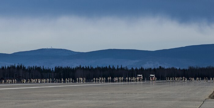Airmen from Eielson Air Force Base, Alaska, conduct a wing-wide foreign-object debris (FOD) walk, April 11, 2016, to remove materials from the runway that could damage an aircraft during a takeoff or landing. Approximately 800 Airmen from the 354th Fighter Wing and tenant units covered five and a half miles of Eielson’s taxiways and runways in preparation for RED-FLAG-Alaska. 