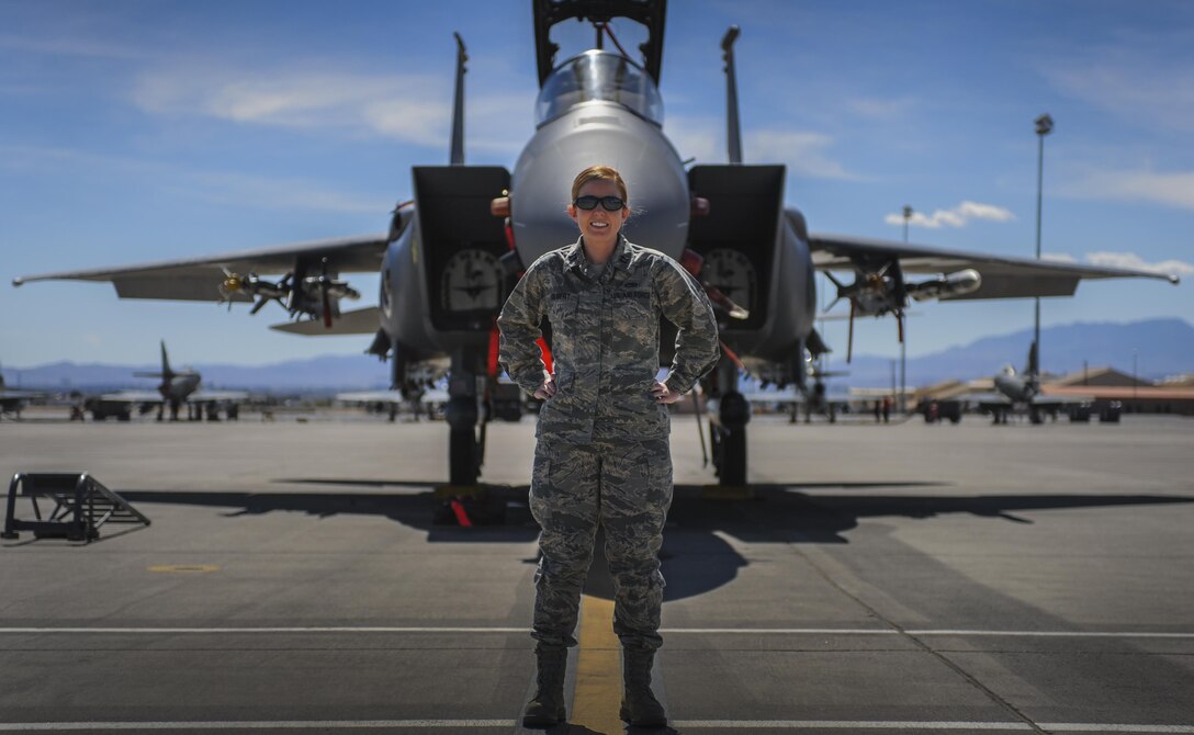 Capt. Madison Gilbert, 757th Aircraft Maintenance Squadron, officer in charge, stands in front of F-15E Strike Eagle on the Nellis Air Force Base, flight line, March 31. As the OIC, she is responsible for 16, F-15E Strike Eagle aircraft and 170 maintainers.