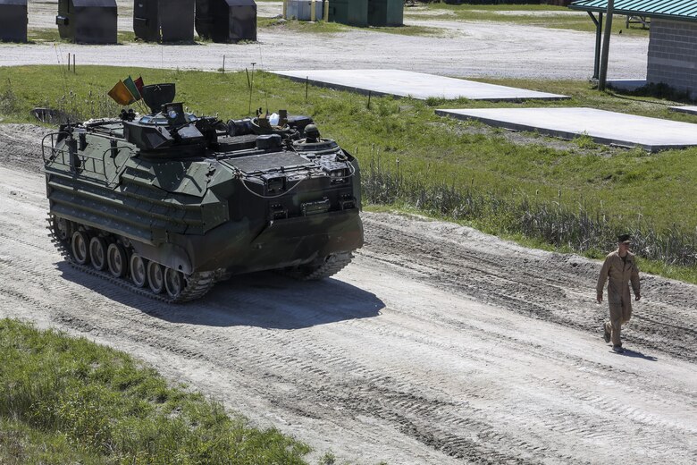 A Marine with Alpha Company, 2nd Assault Amphibian Battalion guides an amphibious assault vehicle during a gunnery skills exercise at Camp Lejeune, N.C., April 13, 2016. The company conducted the training to prepare for their upcoming participation in the Integrated Training Exercise. (U.S. Marine Corps photo by Cpl. Paul S. Martinez/Released)