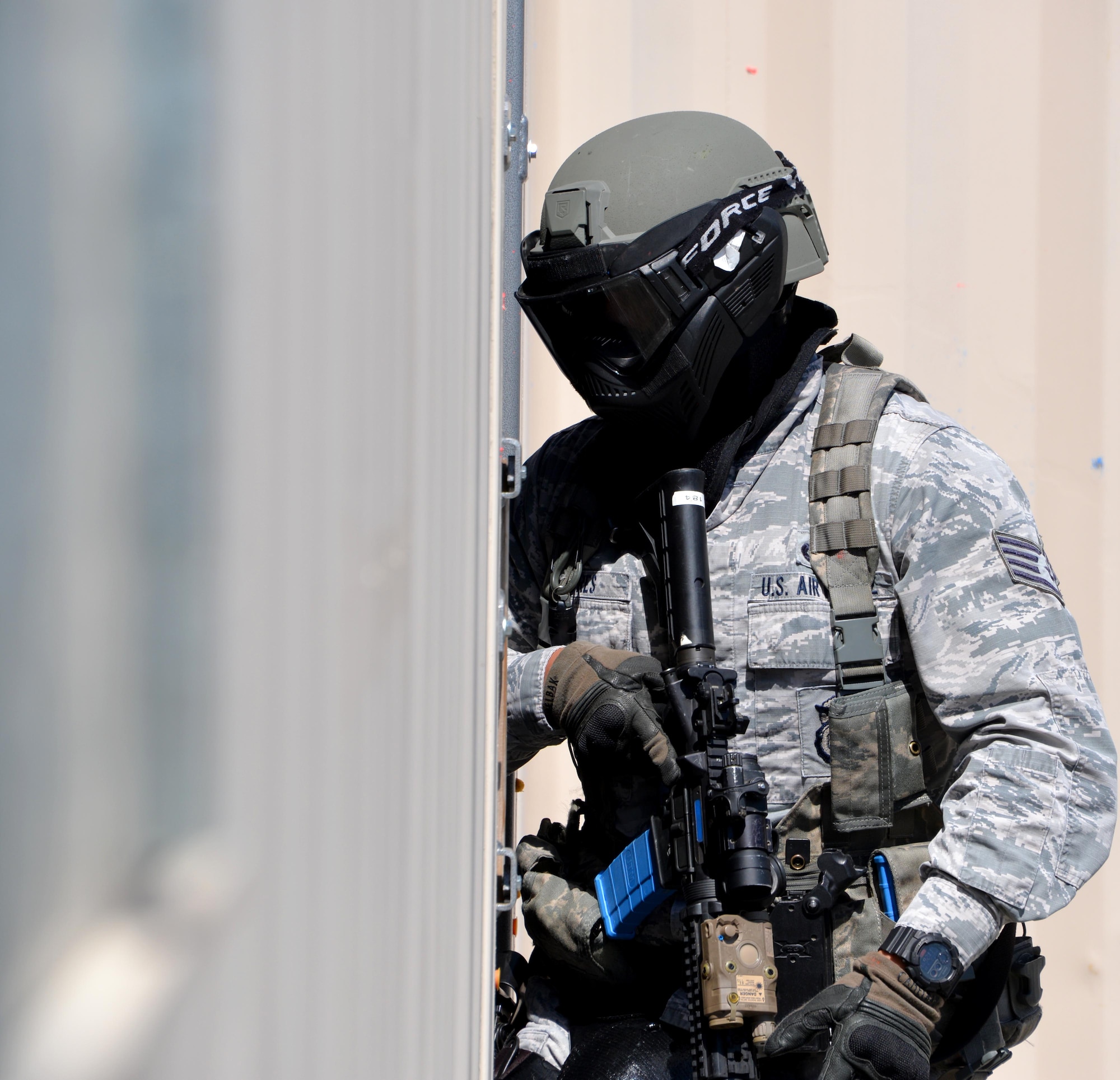 A staff sergeant assigned to the 60th Security Forces Squadron enters a structure in an attempt to clear the building of a simulated active shooter threat April 13, 2016, at Travis Air Force Base, California. The training event was part of the annual requirement for security forces Airmen to train on active shooter incidents. (U.S. Air Force photo by Staff Sgt. Charles Rivezzo)