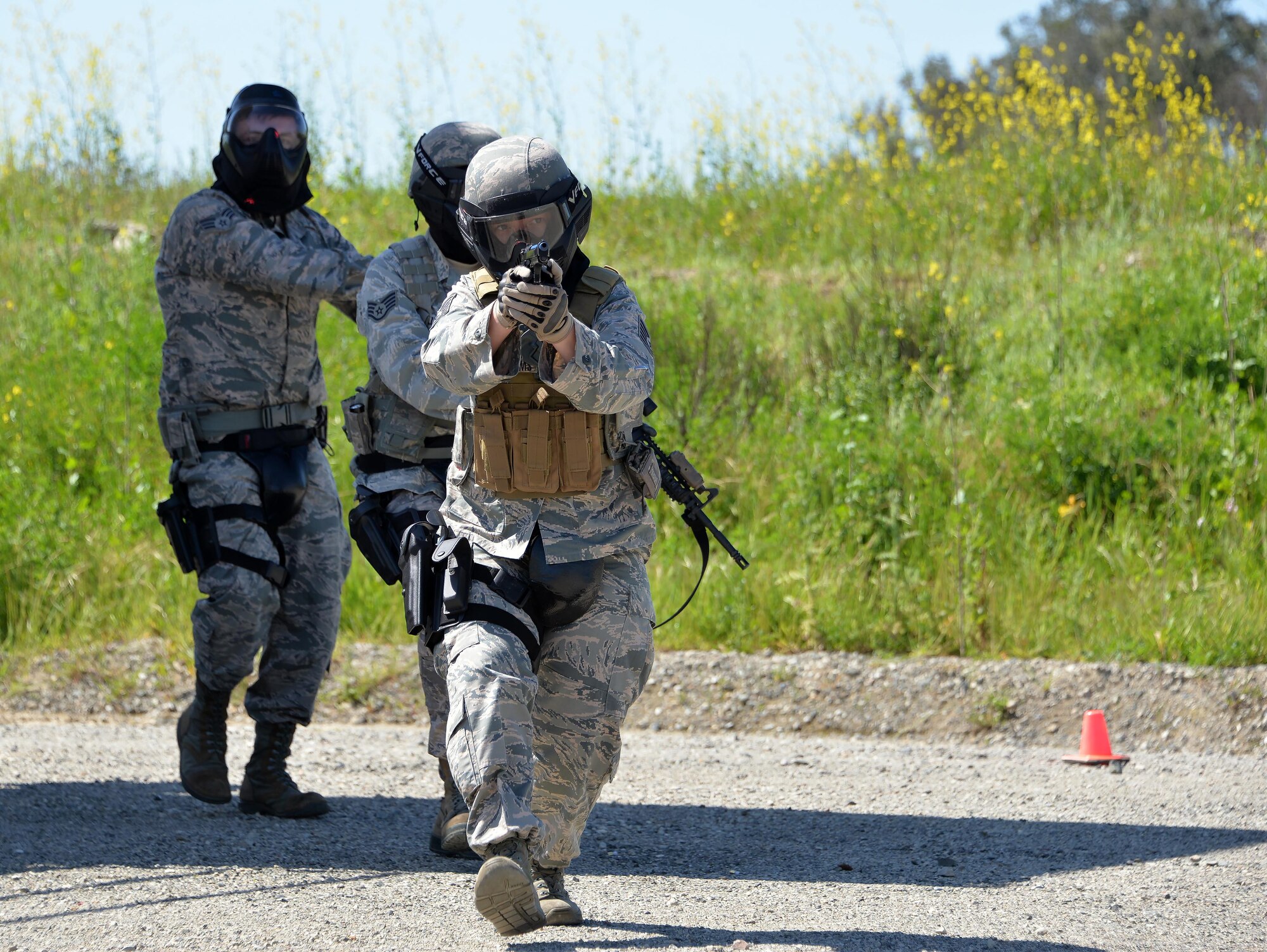 Tech. Sgt. Brooke Williams, 60th Security Forces Squadron raven program manager, runs as the point person on a security team responding to a simulated active shooter event April 13, 2016, at Travis Air Force Base, California. As a Phoenix Raven, Williams provides close-in security for Air Mobility Command aircraft transiting airfields where security is unknown or additional security is needed to counter local threats. (U.S. Air Force photo by Staff Sgt. Charles Rivezzo) 