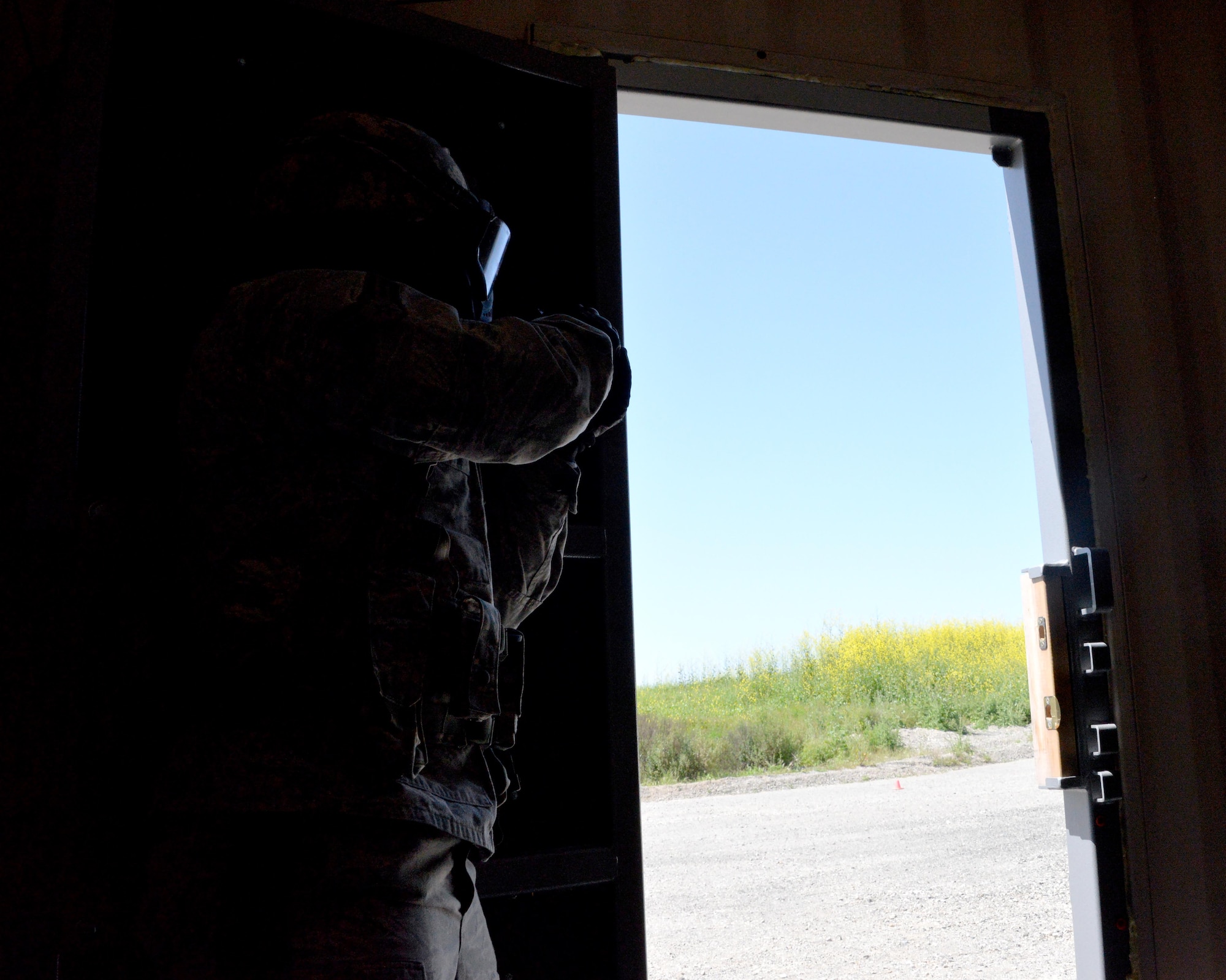An airman first class assigned to the 60th Security Forces Squadron works to clear a building during an active shooter training event April 13, 2016, at Travis Air Force Base, California. The active shooter training took place at the installation’s newly constructed Emergency Responder Urban Training Site. (U.S. Air Force photo by Staff Sgt. Charles Rivezzo)