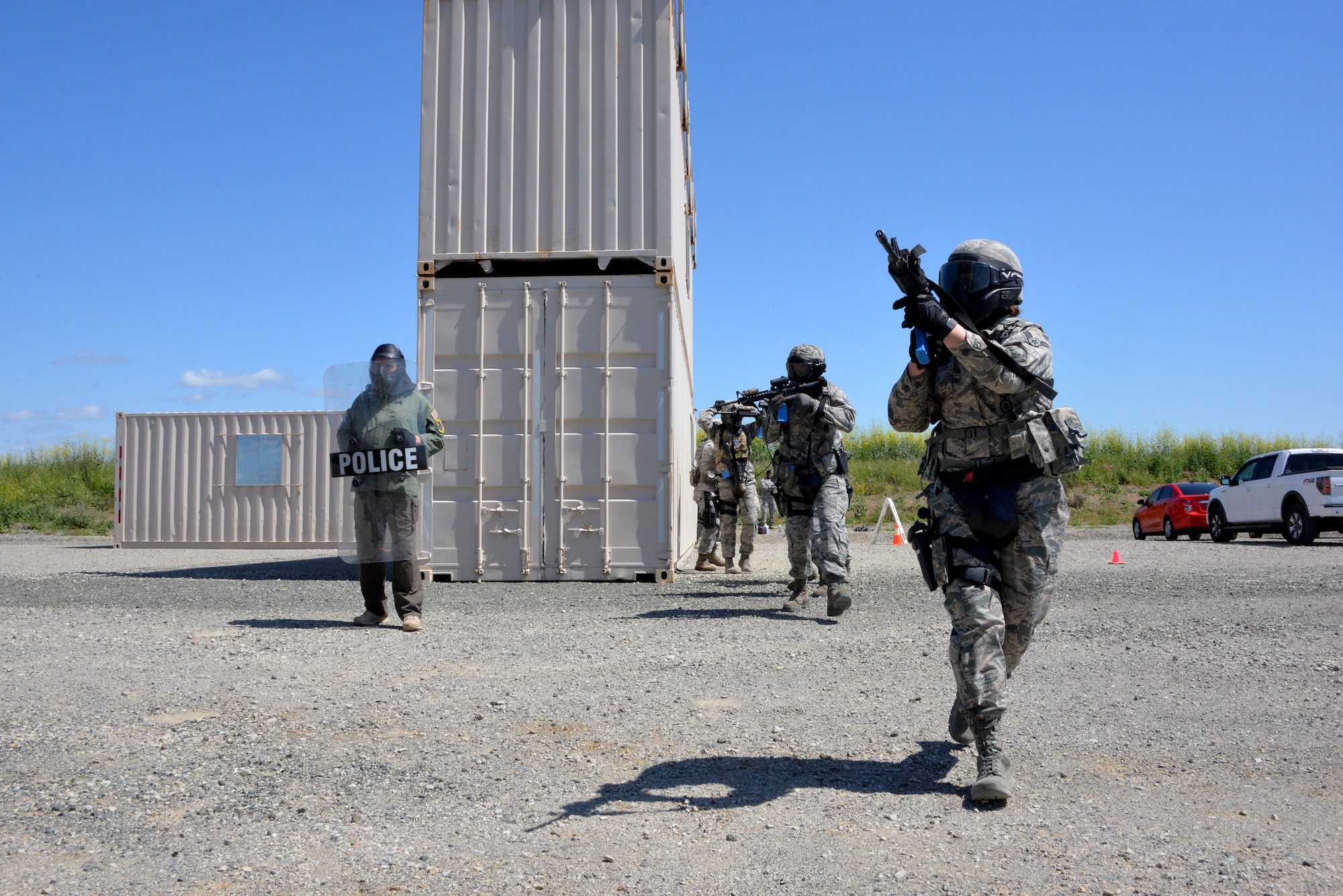 Airmen assigned to the 60th Security Forces Squadron move toward the sound of gunfire during an active shooter training event April 13, 2016, at Travis Air Force Base, California. (U.S. Air Force photo by Staff Sgt. Charles Rivezzo)