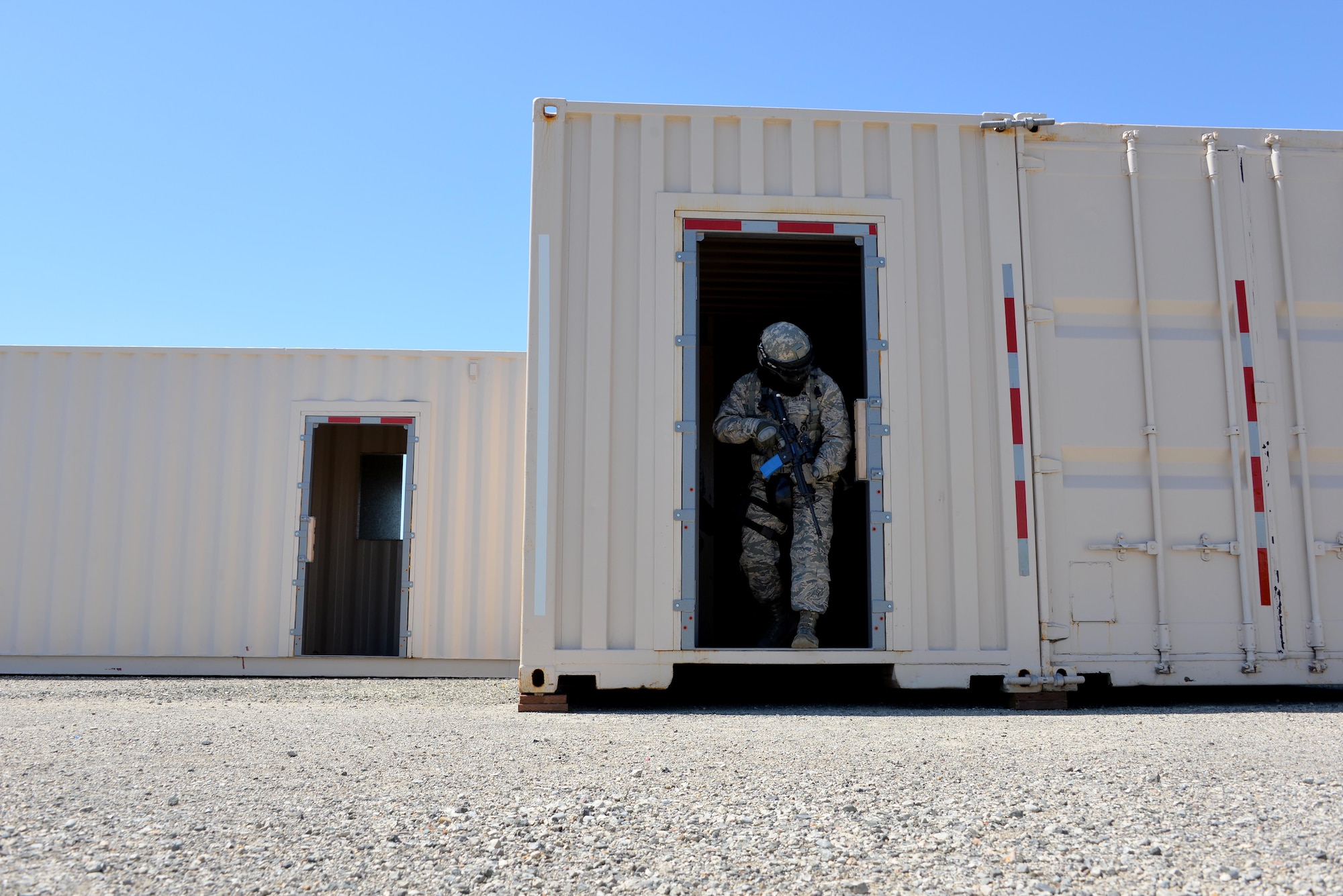 Airmen assigned to the 60th Security Forces Squadron exit a structure after clearing the building during an active shooter training event April 13, 2016, at Travis Air Force Base, California. (U.S. Air Force photo by Staff Sgt. Charles Rivezzo)