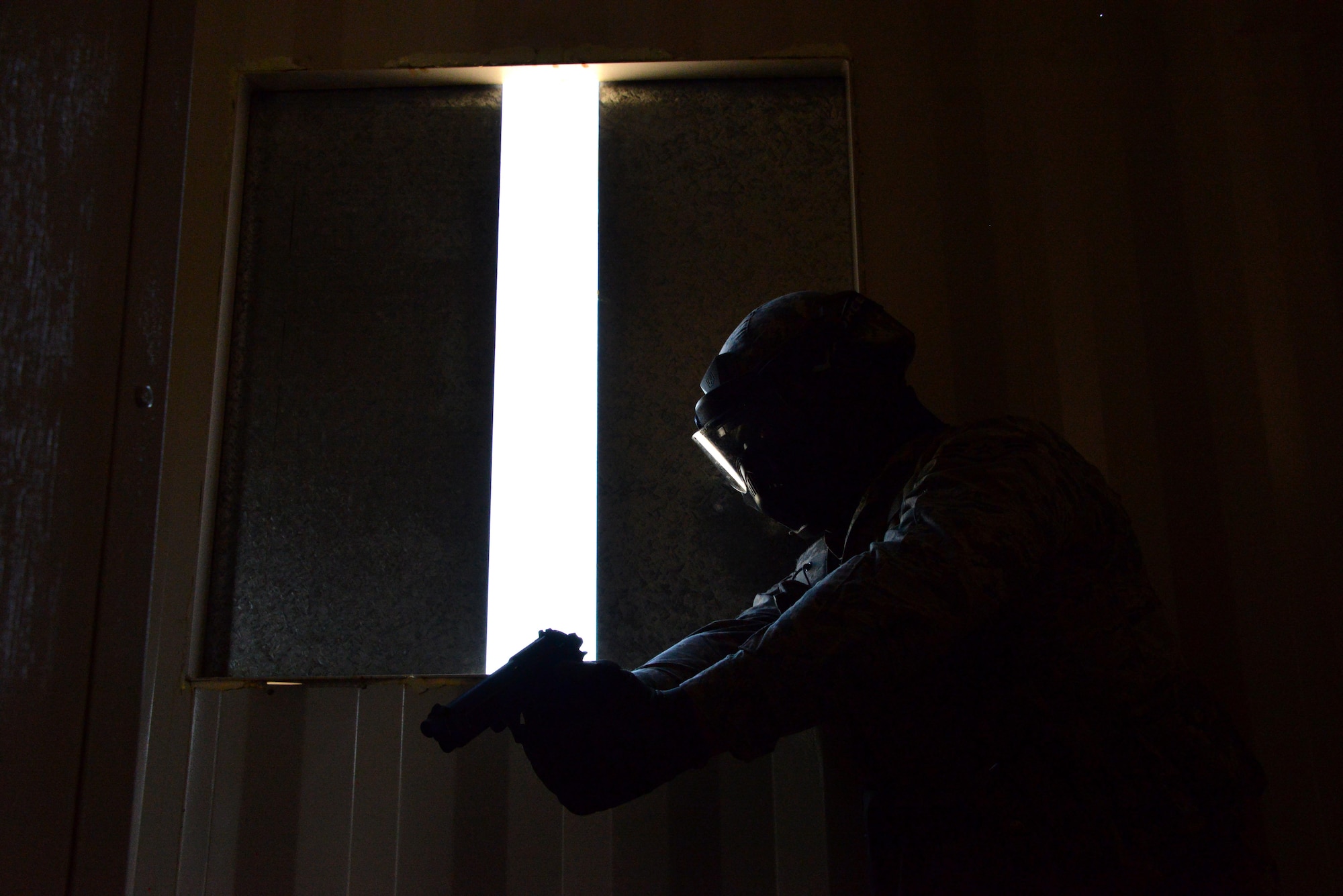 An airman first class assigned to the 60th Security Forces Squadron works to clear a building during an active shooter training event April 13, 2016, at Travis Air Force Base, California. The active shooter training took place at the installation’s newly constructed Emergency Responder Urban Training Site. (U.S. Air Force photo by Staff Sgt. Charles Rivezzo)