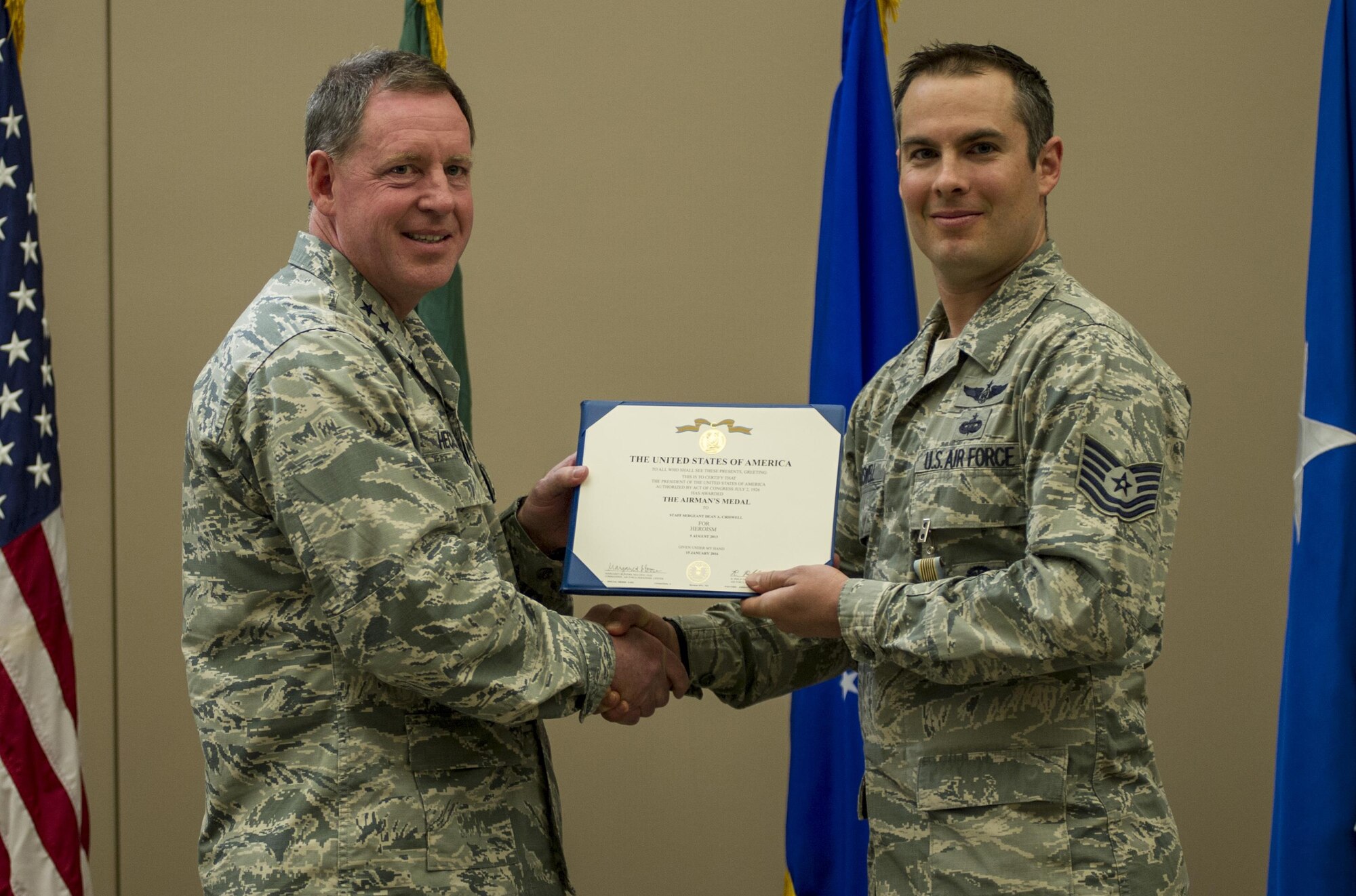 Tech. Sgt. Dean Criswell, right, the 22nd Special Tactics Squadron NCO in charge of rescue operations, receives the Airman’s medal during a ceremony April 8, 2016, at Fairchild Air Force Base, Wash. Criswell and Maj. Matthew Arnold, the 336th Training Group chief of standards and evaluations, put their lives in danger to save the lives of three Airmen on a HH-60G Pave Hawk that crashed during training. (U.S. Air Force photo/Airman 1st Class Sean Campbell)