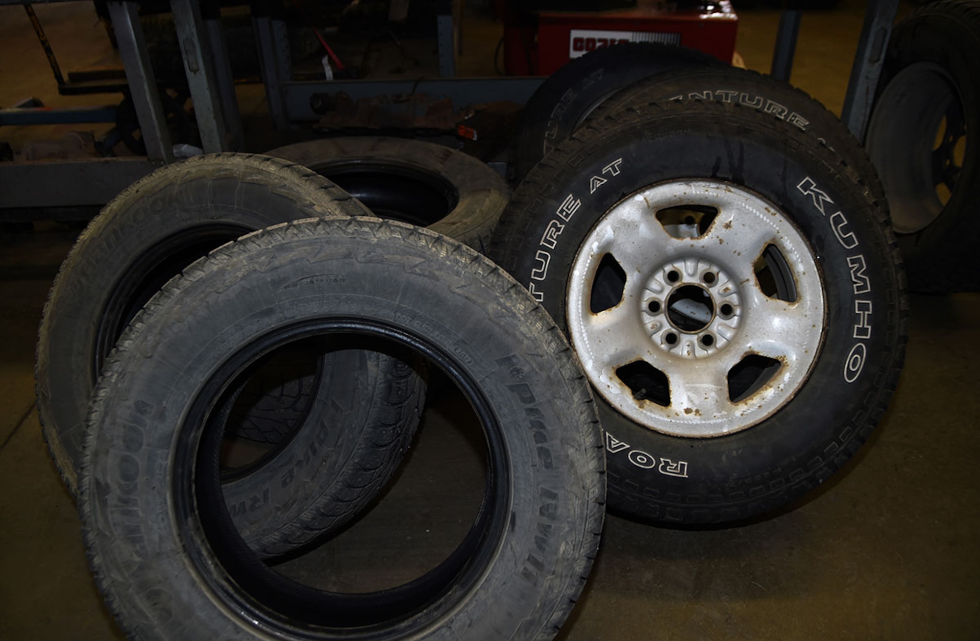 A set of winter tires are dismounted while a set of summer tires are mounted on rims at the Auto Skills Center, Joint Base Elmendorf-Richardson, Alaska, April 14, 2016. According to the Division of Motor Vehicles, it is unlawful to operate a motor vehicle with studded tires on a paved highway or road from May 1 through September 15. (U.S. Air Force photo by Staff Sgt. Sheila deVera)