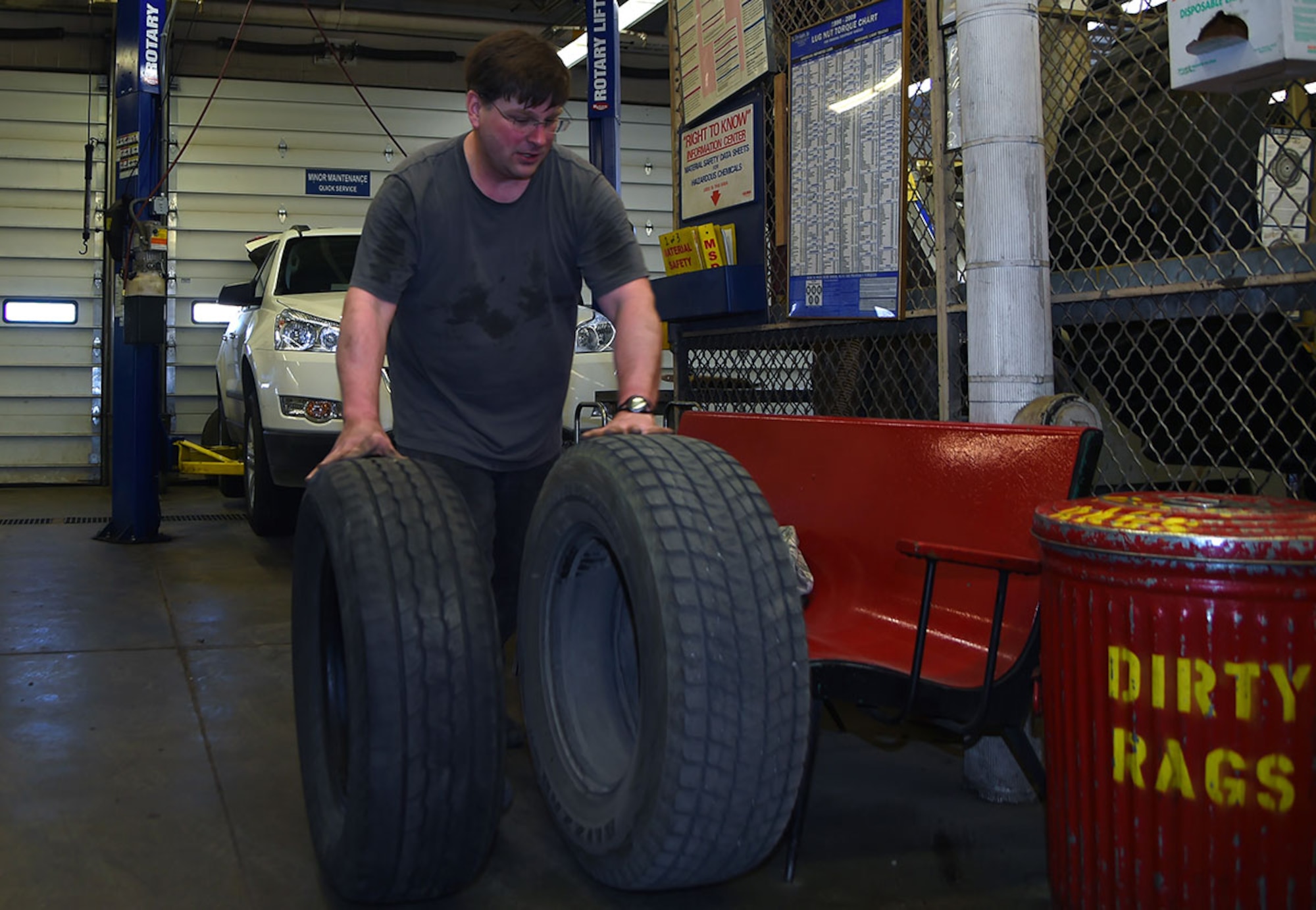 Daniel Stimpfel, a retiree, rolls a tires to the tire changer at the Auto Skills Center, Joint Base Elmendorf-Richardson, Alaska, April 14, 2016. (U.S. Air Force photo by Staff Sgt. Sheila deVera)