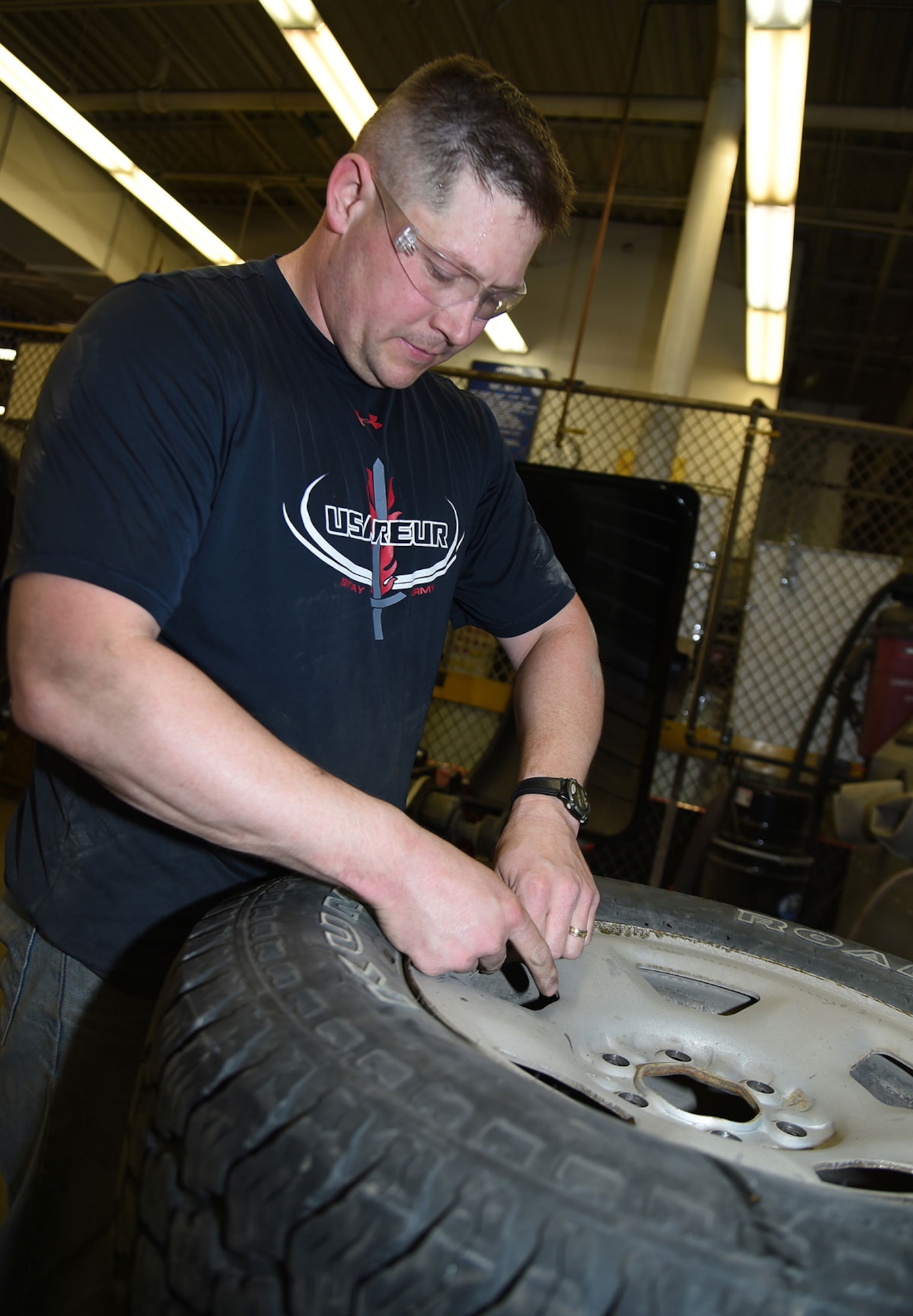 U.S. Army Sgt. Caleb Morrison, senior patrolman, mounts one of his summer tires, April 14, 2016. According to the Division of Motor Vehicles, it is unlawful to operate a motor vehicle with studded tires on a paved highway or road from May 1 through September 15. Morrison is attached to the 545th Military Police Company, 6th Brigade Engineer Battalion (Airborne), 4th Infantry Brigade Combat Team (Airborne), 25th Infantry Division. (U.S. Air Force photo by Staff Sgt. Sheila deVera)