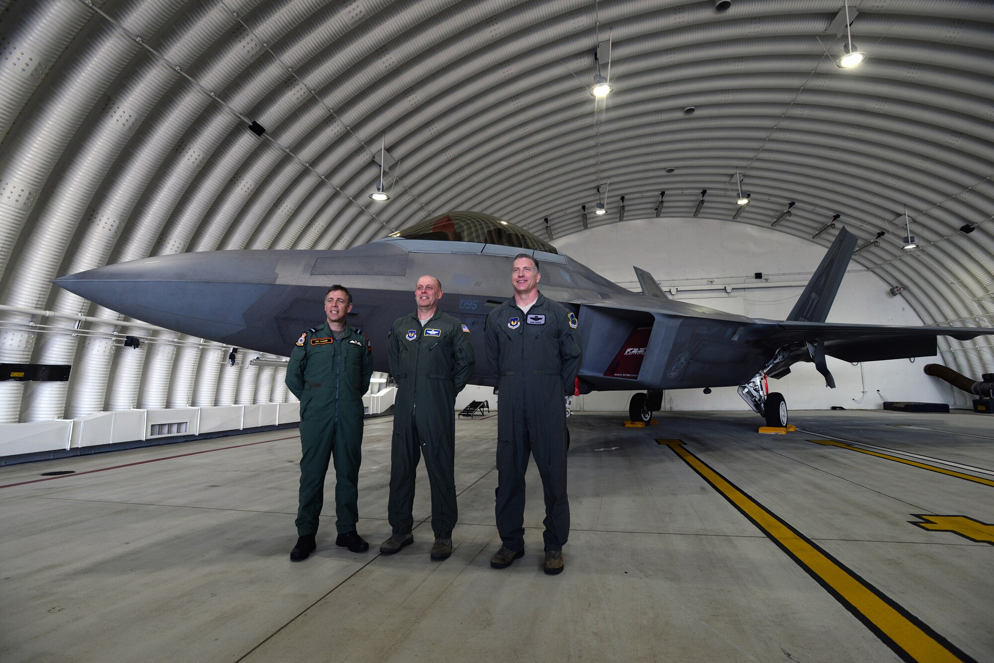 Maj. Gen. Eric Vollmecke, Air National Guard Assistant to the United States Air Forces in Europe Air Forces Africa Commander (center), Col. David Eaglin, 48th Fighter Wing vice commander (right), and Air Commodore Ian Duguid, Typhoon Force commander, stand in front of an F-22 Raptor for a group photo during a press briefing at Royal Air Force Lakenheath, England, April 14. The press briefing covered the largest F-22 Raptor training deployment to the United Kingdom. The F-22s deployed from the 95th Fighter Squadron at Tyndall Air Force Base, Fla., will conduct air training with other Europe-based aircraft while demonstrating U.S. commitment to NATO allies and the security of Europe. (U.S. Air Force photo by Tech. Sgt. Eric Burks/ Released)