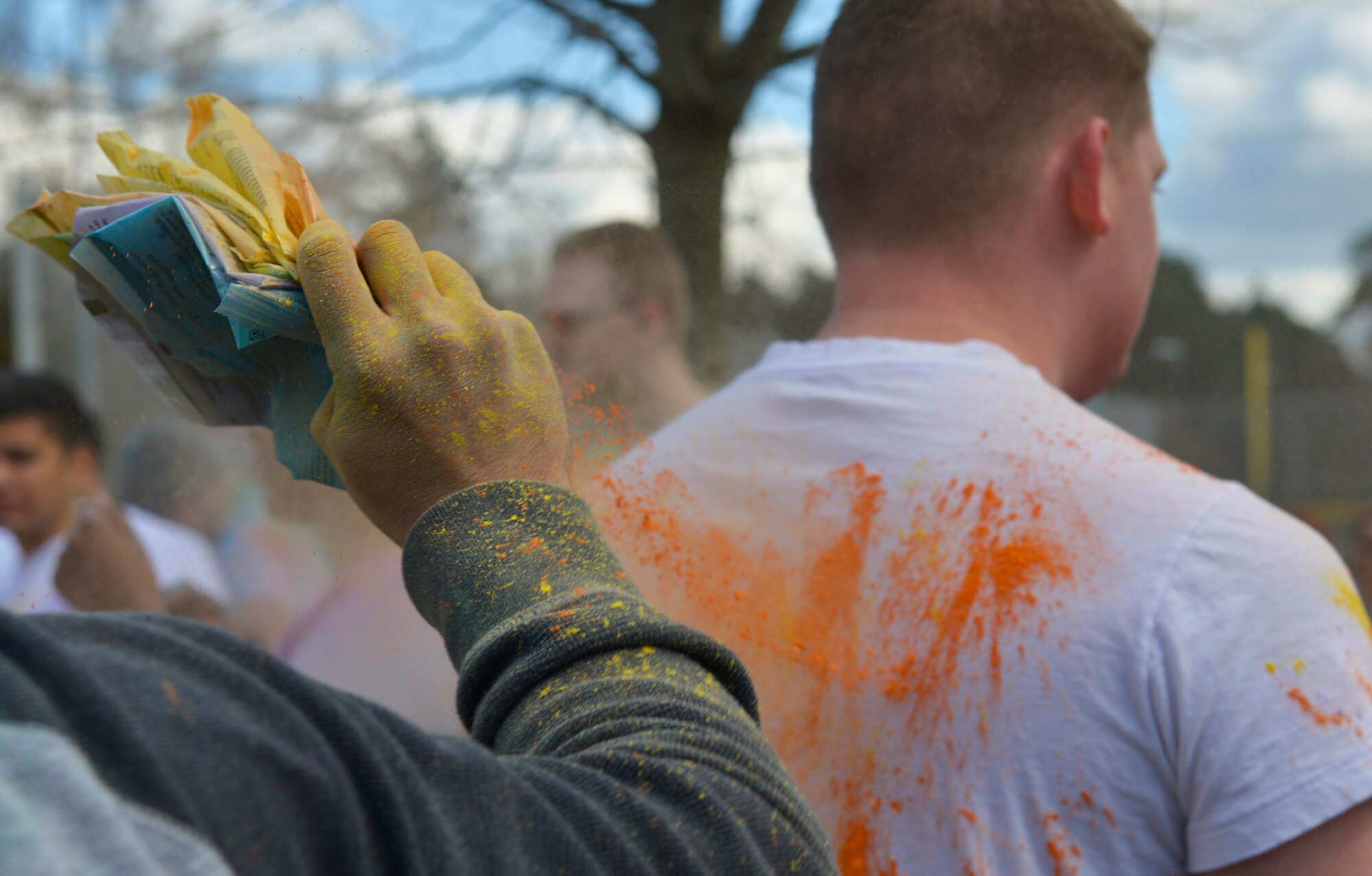 Colored powder is splashed on a runner waiting for the 2016 Air Force Assistance Fund Color Run to begin April 7, 2016, at Ramstein Air Base, Germany. The run brought the Kaiserslautern Military Community together to raise money for the AFAF’s four foundations, designed to help Airmen and retirees through financial issues and other tough situations. (U.S. Air force photo/Airman 1st Class Lane T. Plummer) 