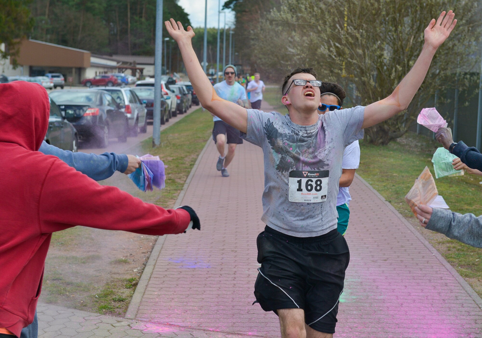 A runner sprints through the finish line during the 2016 Air Force Assistance Fund Color Run April 7, 2016, at Ramstein Air Base, Germany. The run raised money for the AFAF’s four foundations by bringing the Kaiserslautern Military Community together for a 5 kilometer run.