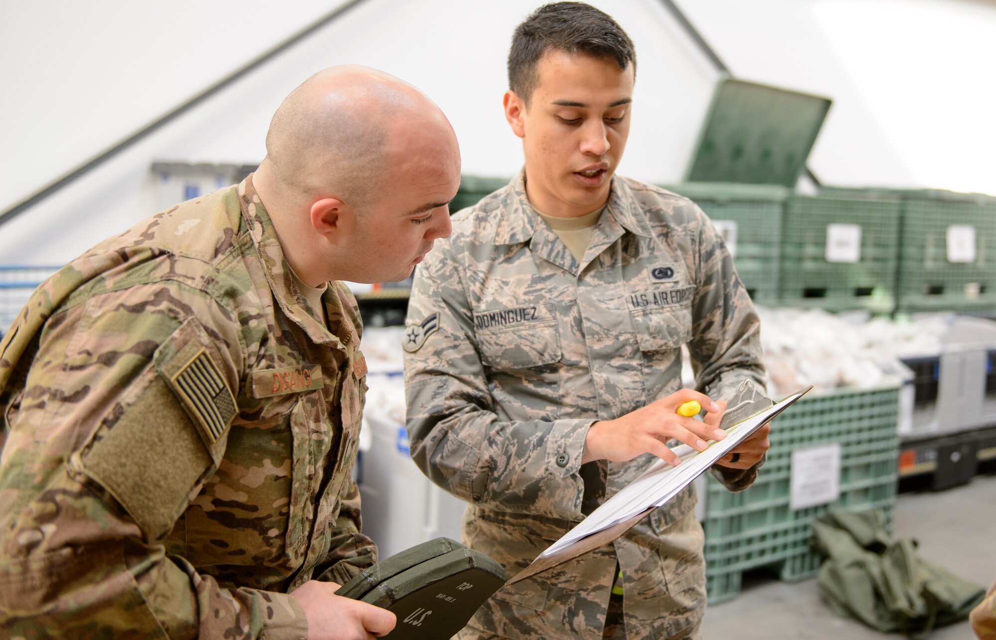 Airman 1st Class Cierra Dominguez, 86th Logistic Readiness Squadron individual protective equipment journeyman, shows Capt. Rosario Digangi, 435th Contingency Response Squadron operations flight commander, a list of items being issued at Ramstein Air Base, Germany, April 11, 2016. Digangi and other 435th CRS members processed through a deployment line to ensure all documents and procurement of necessary equipment was completed for a future missions. (U.S. Air Force photo/Staff Sgt. Armando A. Schwier-Morales)