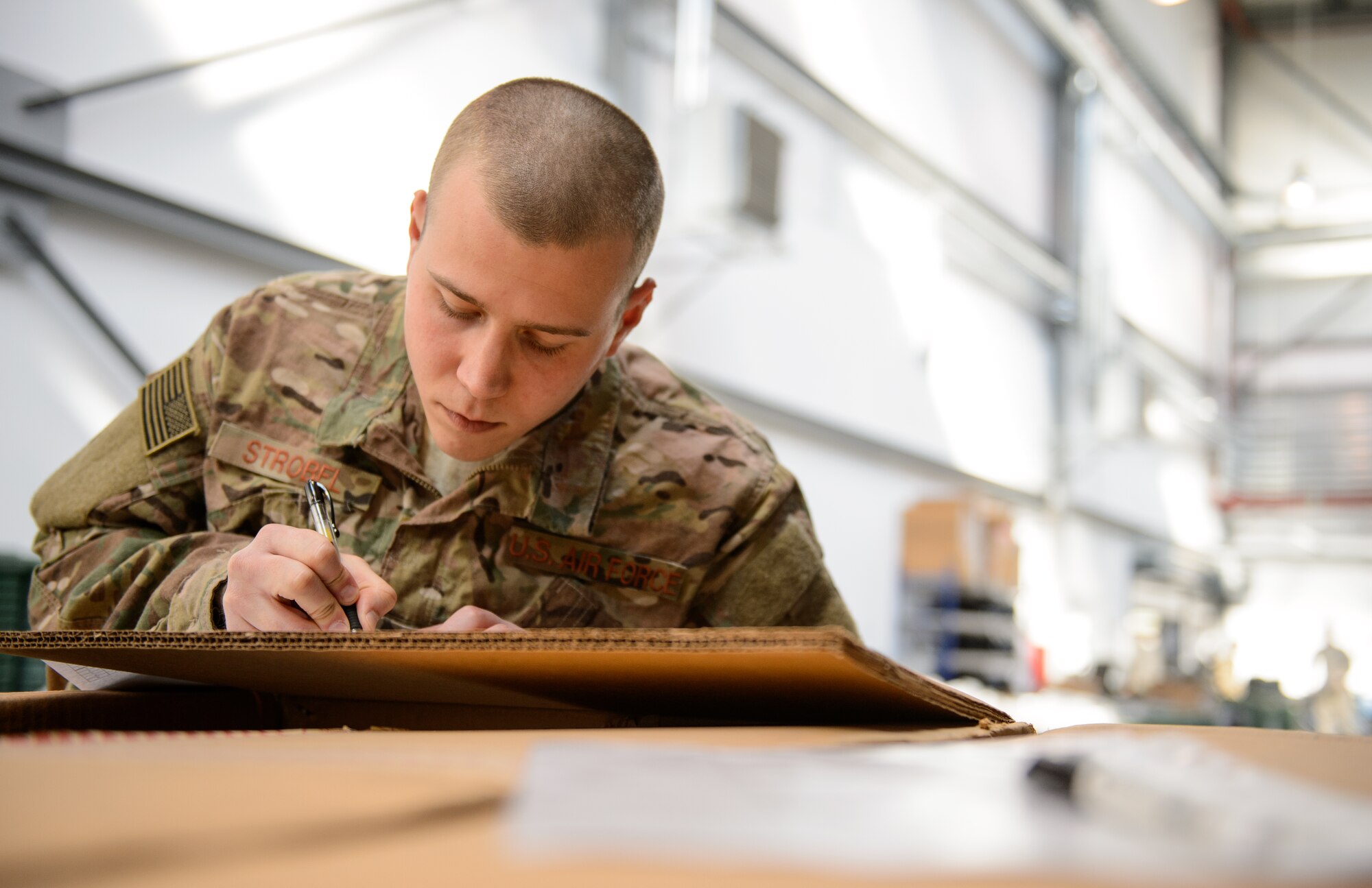 Senior Airman Zachary Strobel, 435th Contingency Response Squadron contingency aerospace maintenance journeyman, signs a receipt for equipment at Ramstein Air Base, Germany, April 11, 2016. Strobel is part of deployment from the 435th CRS going to stand up a base from a piece of flat land. (U.S. Air Force photo/Staff Sgt. Armando A. Schwier-Morales) 