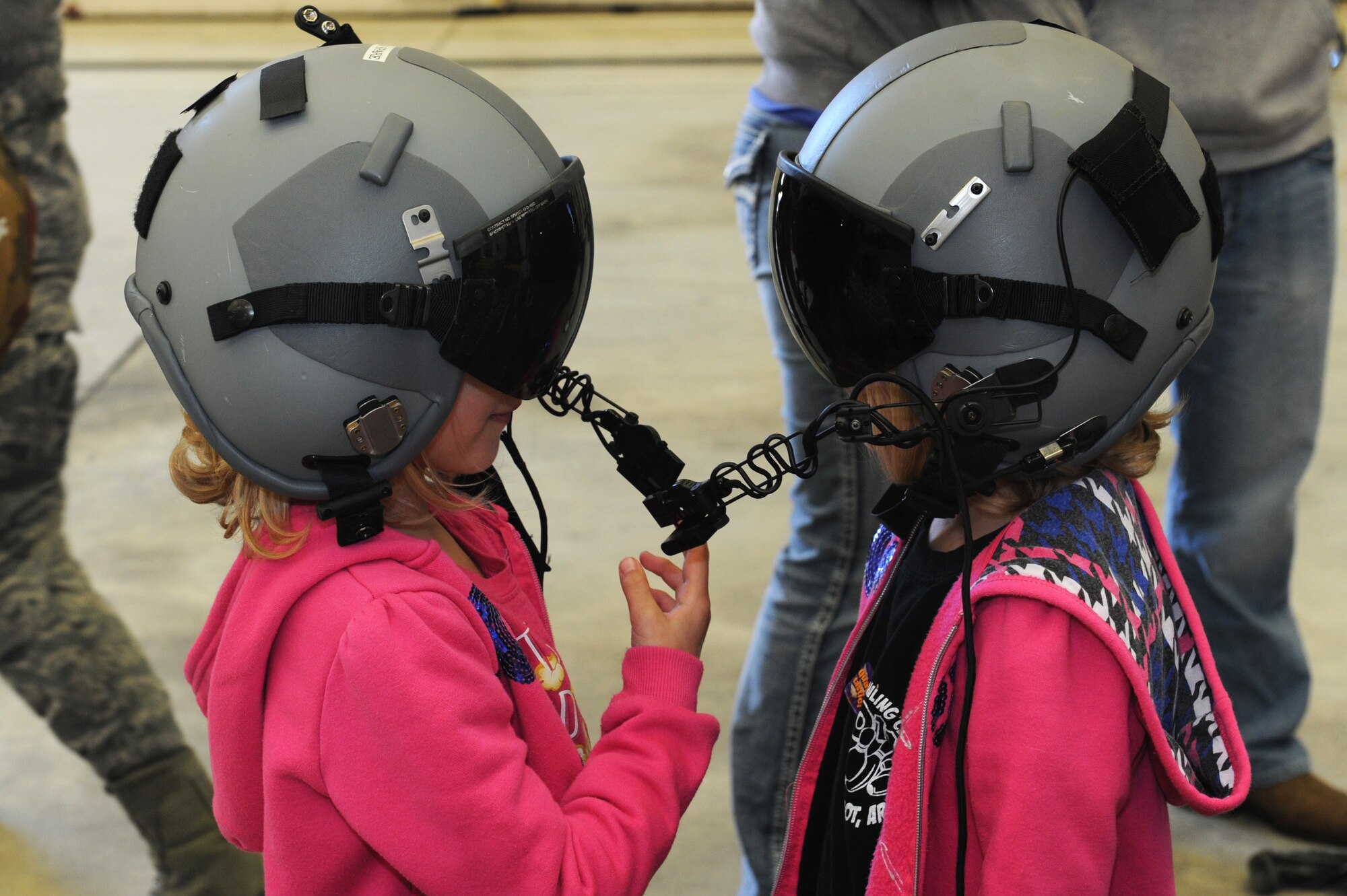 Ava and Amber Chambliss, daughters of U.S. Air Force Master Sgt. Joshua Chambliss 19th Security Forces First Sergeant, participate in a mock pre-deployment line early in the morning at a hangar on the flightline, April 9, 2016, on Little Rock Air Force Base, Ark.  The girls were part of the Kids Understanding Deployment Operations experience, an event geared at explaining deployment procedures to children.  (U.S. Air Force photo by Amn Grace Nichols)