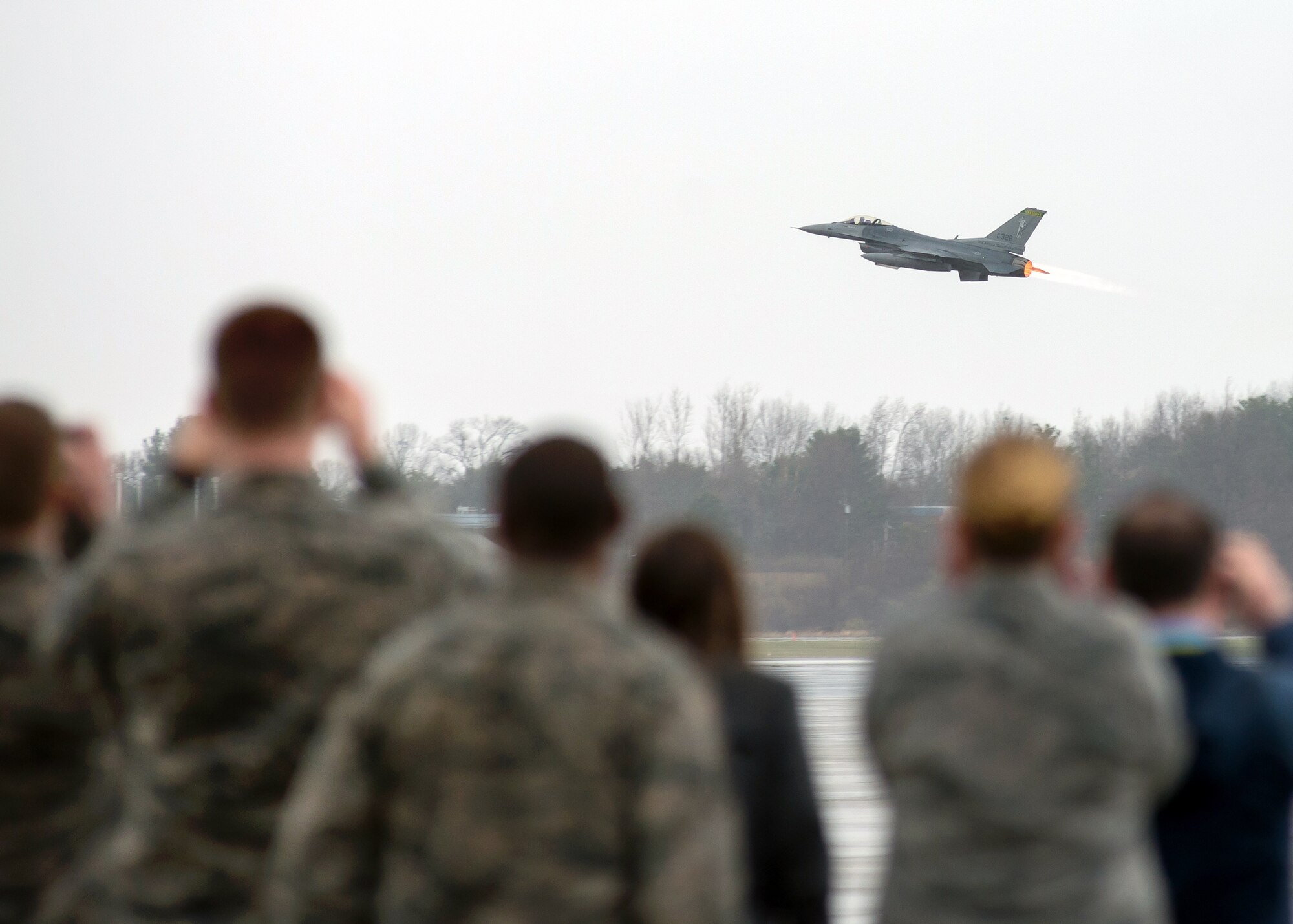 Airmen watch as a Vermont Air National Guard F-16 takes off  from the Hanscom flightline April 12. The fighter jets from the 158th Fighter Wing were at Hanscom after participating in the Boston Red Sox opening day festivities at Fenway Park the day before. (U.S. Air Force photo by Mark Herlihy)