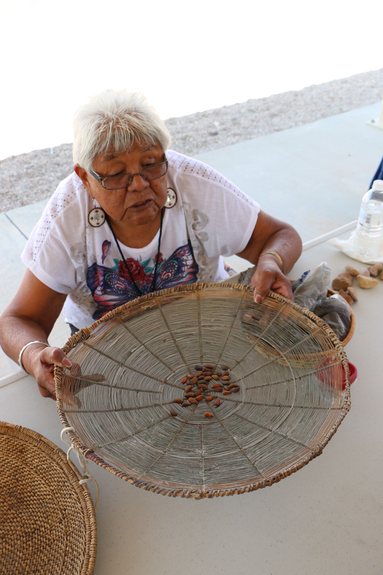 A member of the Paiute Tribe of Utah processes pine nuts during the 2015 Annual American Indian Meeting, co-hosted last August in Cedar City by Hill Air Force Base and the Paiute Tribe of Utah. The Air Force consults with 21 American Indian Tribes who claim cultural affiliation to lands managed by Hill AFB. The base and other military installations in Utah sponsor the annual meeting to allow tribal leadership to meet with military leadership face-to-face to discuss upcoming projects on military lands and to address any tribal concerns. (U.S. Air Force Photo by Jamie Brand)
