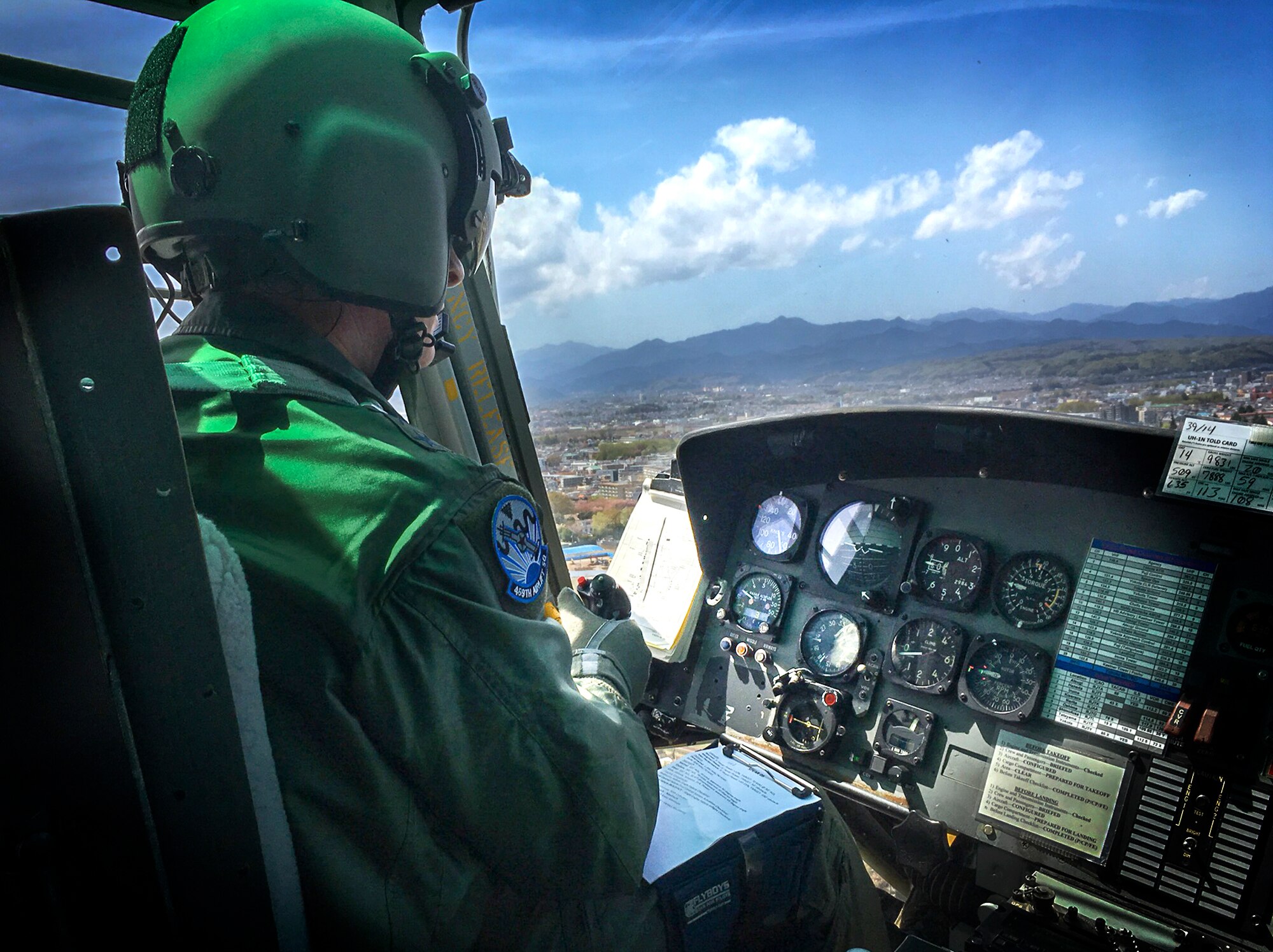 Lt. Gen. John Dolan, U.S. Forces, Japan and 5th Air Force commander, pilots a 459th Airlift Squadron UH-1N Iroquois over Yokota Air Base, Japan, April 11, 2016. The UH-1N, also known as the “Huey,” is a personnel transport helicopter suited for transit and search and rescue operations. (U.S. Air Force photo by Tech. Sgt. David Jacobs/Released)