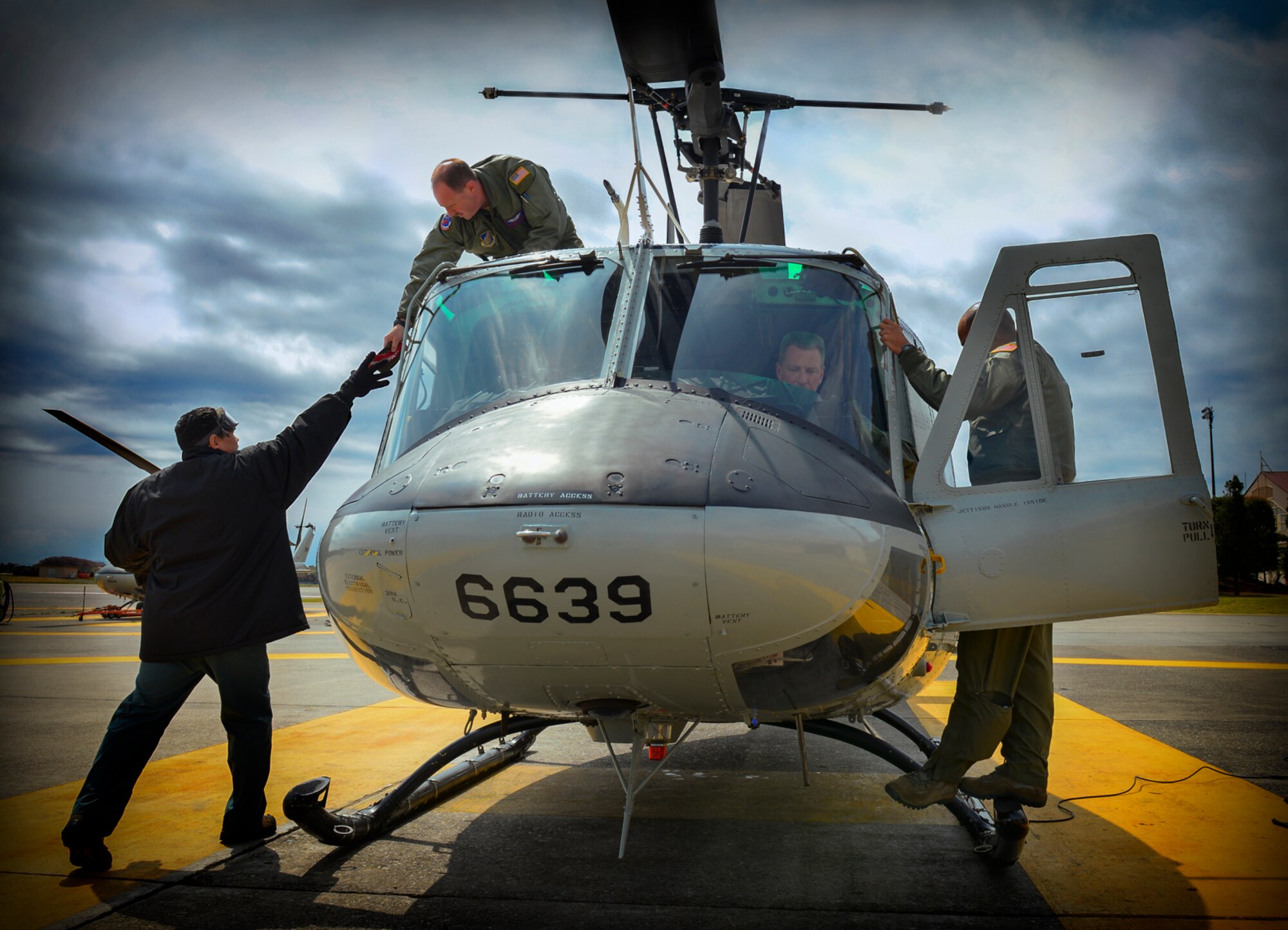 The crew of a UH-1N Iroquois and Lt. Gen. John Dolan, U.S. Forces, Japan and 5th Air Force commander, prepare for flight at Yokota Air Base, Japan, April 11, 2016. Several key leaders at Yokota have flown 459th Airlift Squadron UH-1Ns as part of key staff pilot courses, including Dolan, Col. Douglas DeLaMater, 374th Airlift Wing commander, and Col. Robert Dotson, 374th Operations Group commander.. (U.S. Air Force photo by Airman 1st Class Elizabeth Baker/Released)