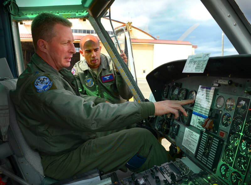 Lt. Gen. John Dolan, U.S. Forces, Japan and 5th Air Force commander, reviews the control panel of a UH-1N Iroquois with help from Capt. Brandon Jones, 459th Airlift Squadron chief of standards and evaluation, at Yokota Air Base, Japan, April 11, 2016. Jones assisted Dolan with piloting a UH-1N as part of a key staff pilot course, a tradition conducted to help leadership better understand the capabilities within their command. (U.S. Air Force photo by Airman 1st Class Elizabeth Baker/Released)