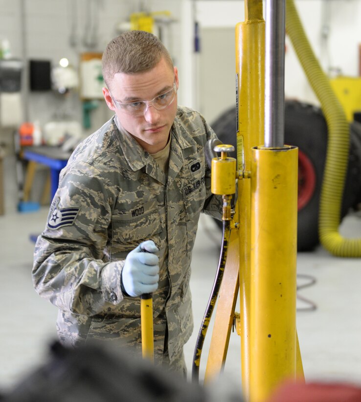 U.S. Air Force Staff Sgt. Chris Wood, 157th Logistics Readiness Squadron special purpose vehicle technician, uses a floor jack to lift a Ford 5.4 liter V8 engine in a 2008 Ford F-150 pickup truck, April 14, 2016, Pease Air National Guard Base, N.H. (U.S. Air National Guard photo by Staff Sgt. Curtis J. Lenz) 