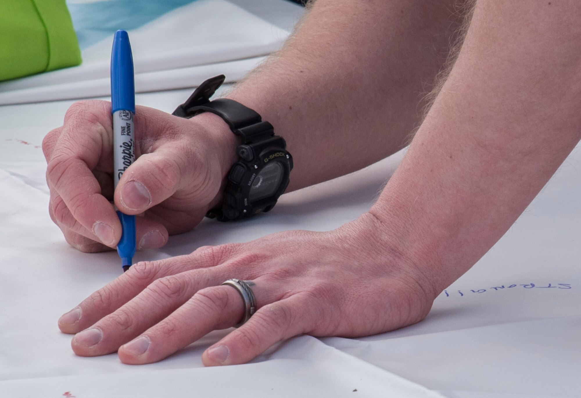 A U.S. Air Force Airman writes a pledge on a poster during Resilient Airman Day at Misawa Air Base, Japan, April 15, 2016. After running a 5K and partaking in a “Silent Walk” in honor of Sexual Assault Awareness and Prevention Month, participants were invited to write a pledge signifying what action they will take to fight against this crime. (U.S. Air Force photo by Airman 1st Class Jordyn Fetter/Released)