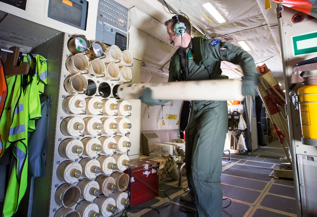 Royal Australian Air Force No 11 Squadron Sergeant Wesley Lock loads sonar buoys onboard an AP-3C Orion maritime patrol aircraft during Exercise Balikatan 2016. 