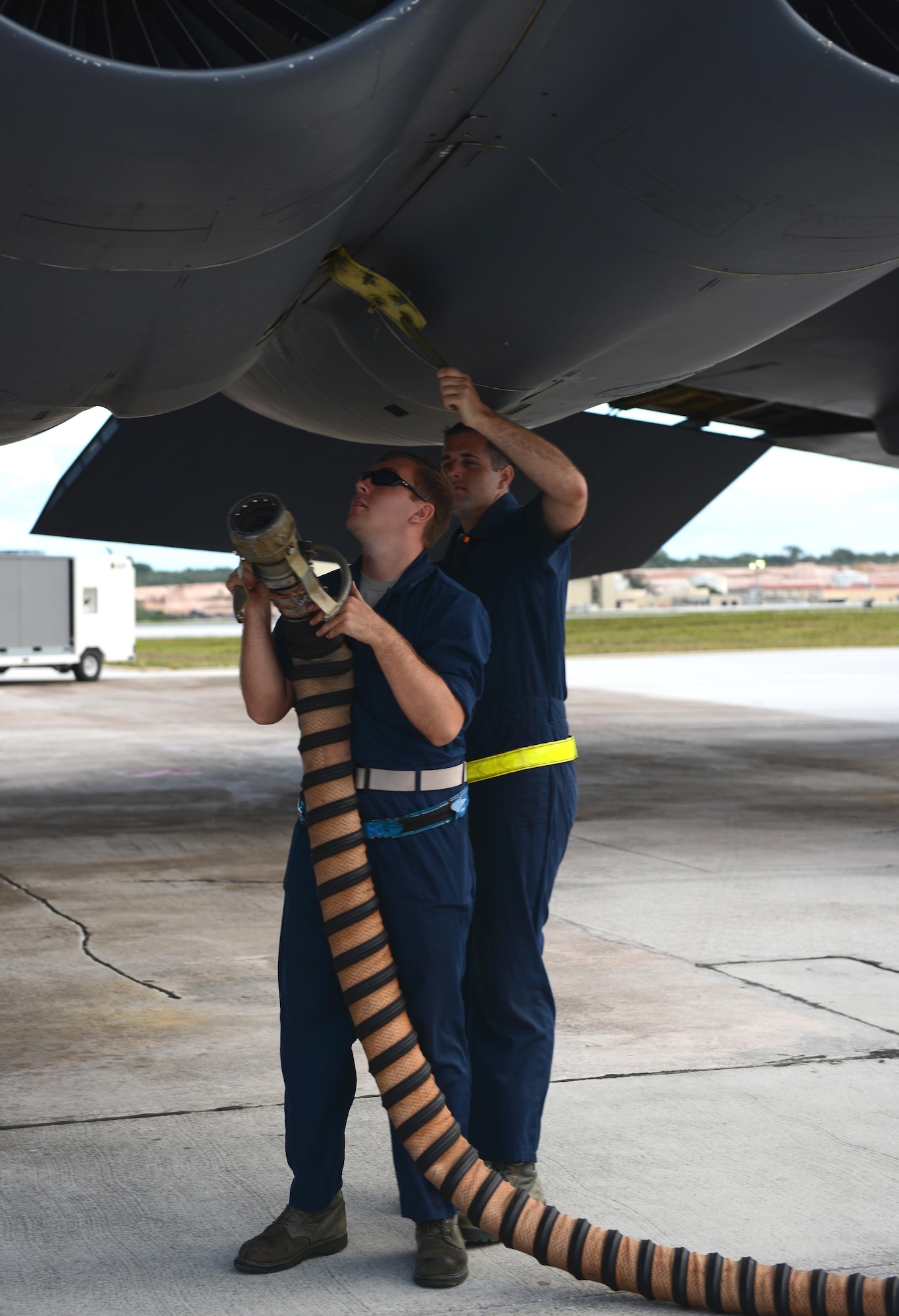 Crew chiefs with the 36th Expeditionary Aircraft Maintenance Squadron connect an aircraft hose to start an engine of a U.S. Air Force B-52 Stratofortress bomber April 14, 2016, at Andersen Air Force Base, Guam. The U.S. Pacific Command has maintained a rotational strategic bomber presence in the Indo-Asia-Pacific region for more than a decade. (U.S. Air Force photo by Airman 1st Class Arielle Vasquez/Released) 