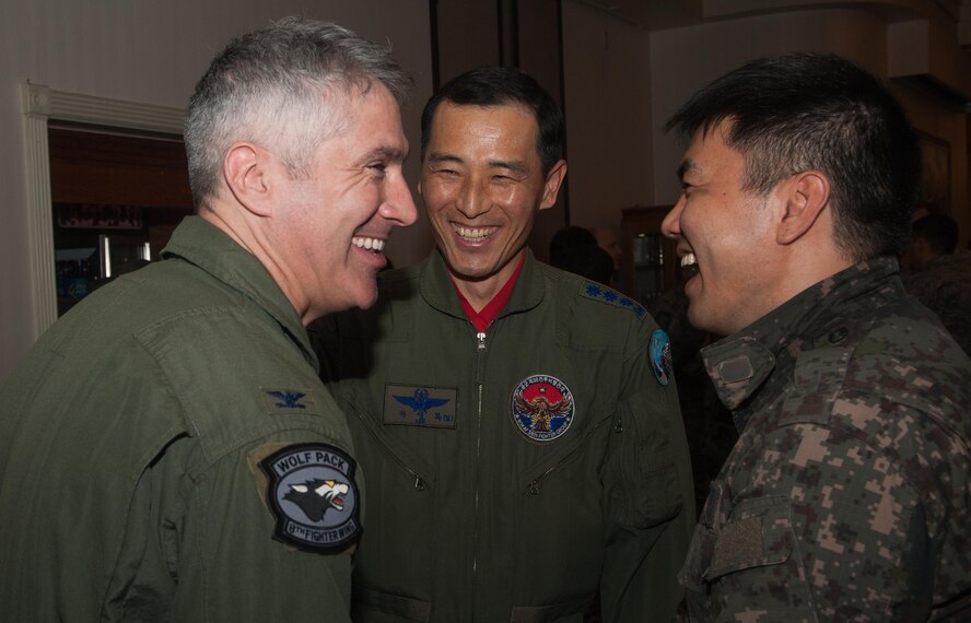 Col. Jeremy Sloane, 8th Fighter Wing commander, Col. Seong-Bok Lee, 38th Fighter Group commander, Col. Bang Jung Ryul, Korean Air Force Operation Command A8 and A9 chief, laugh together during a Max Thunder Ice Breaker April 15, 2016. The Ice Breaker was held to show hospitality and welcome incoming follow-on forces from the Republic of Korea air force, U.S. Navy and the U.S. Marine Corps. (U.S. Air Force photo by Staff Sgt. Nick Wilson)