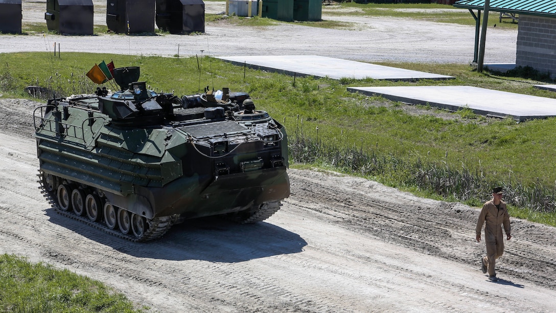 A Marine with Alpha Company, 2nd Assault Amphibian Battalion guides an amphibious assault vehicle during a gunnery skills exercise at Marine COrps Base Camp Lejeune, N.C., April 13, 2016. The company conducted the training to prepare for their upcoming participation in the Integrated Training Exercise. 