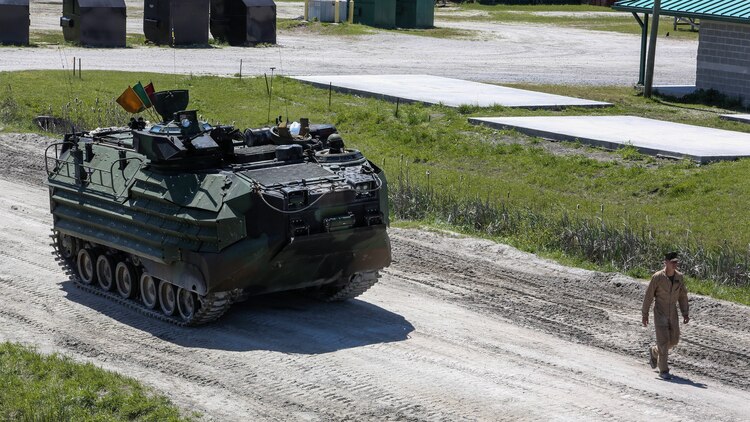 A Marine with Alpha Company, 2nd Assault Amphibian Battalion guides an amphibious assault vehicle during a gunnery skills exercise at Marine COrps Base Camp Lejeune, N.C., April 13, 2016. The company conducted the training to prepare for their upcoming participation in the Integrated Training Exercise. 