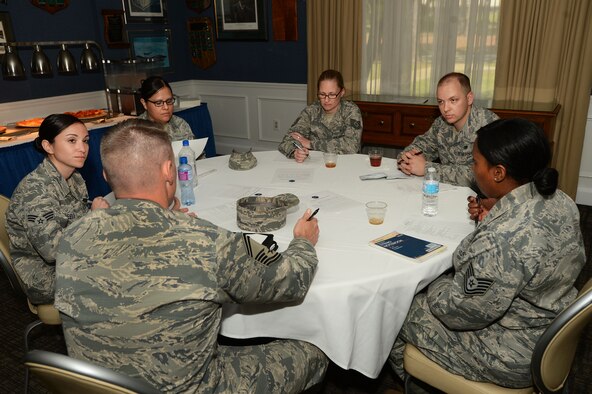 U.S. Air Force noncommissioned officers listen and take notes as a senior master sergeant gives them advice at a speed mentoring event at Shaw Air Force Base, S.C., April 7, 2016. During the event, five groups of NCOs spent seven minutes each with five senior NCOs who were assigned specific topics relating to leadership and career progression on which to offer guidance. (U.S. Air Force photo by Senior Airman Zade Vadnais)